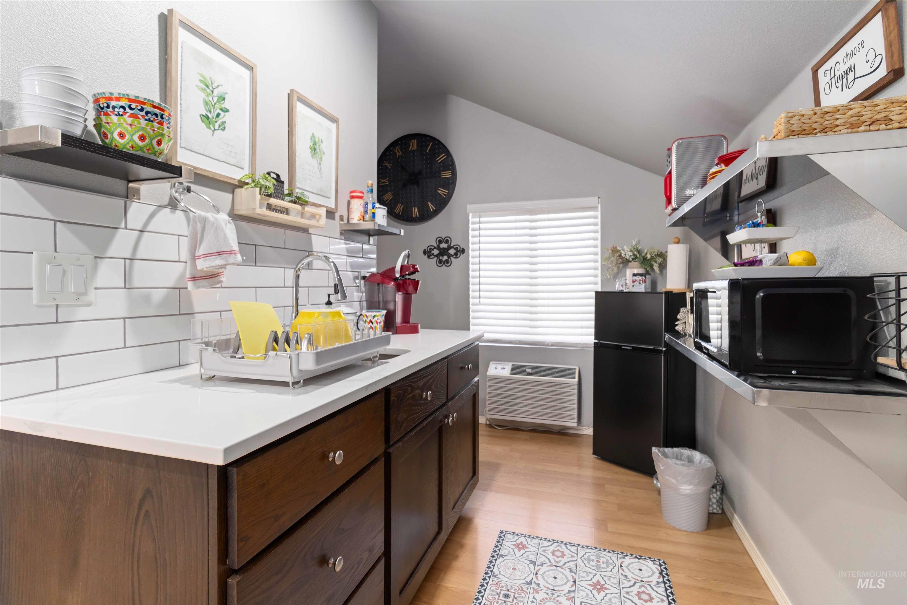 Kitchenette in ADU with sink, microwave, coffee maker and dishes/utensils