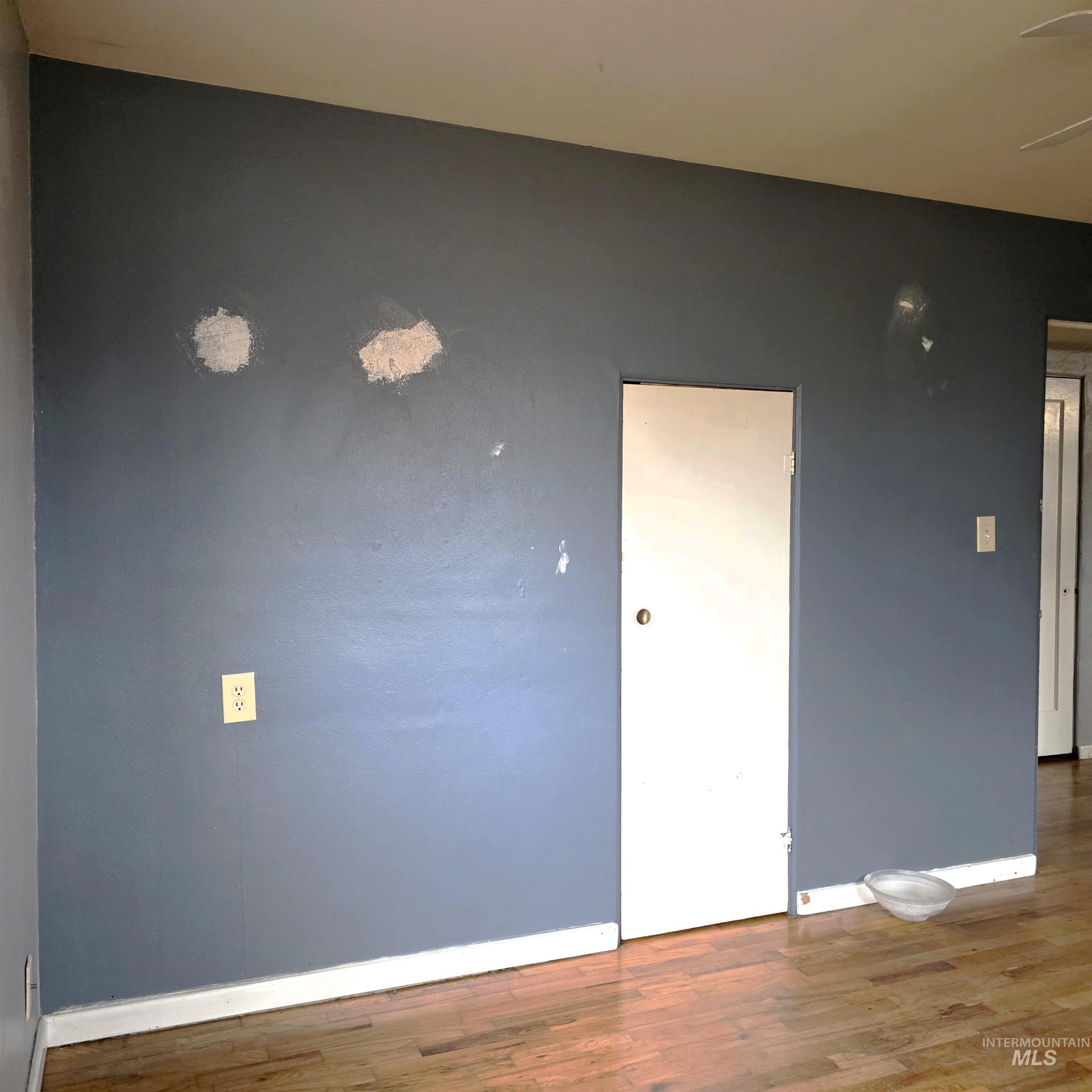 Spare room featuring wood finished floors