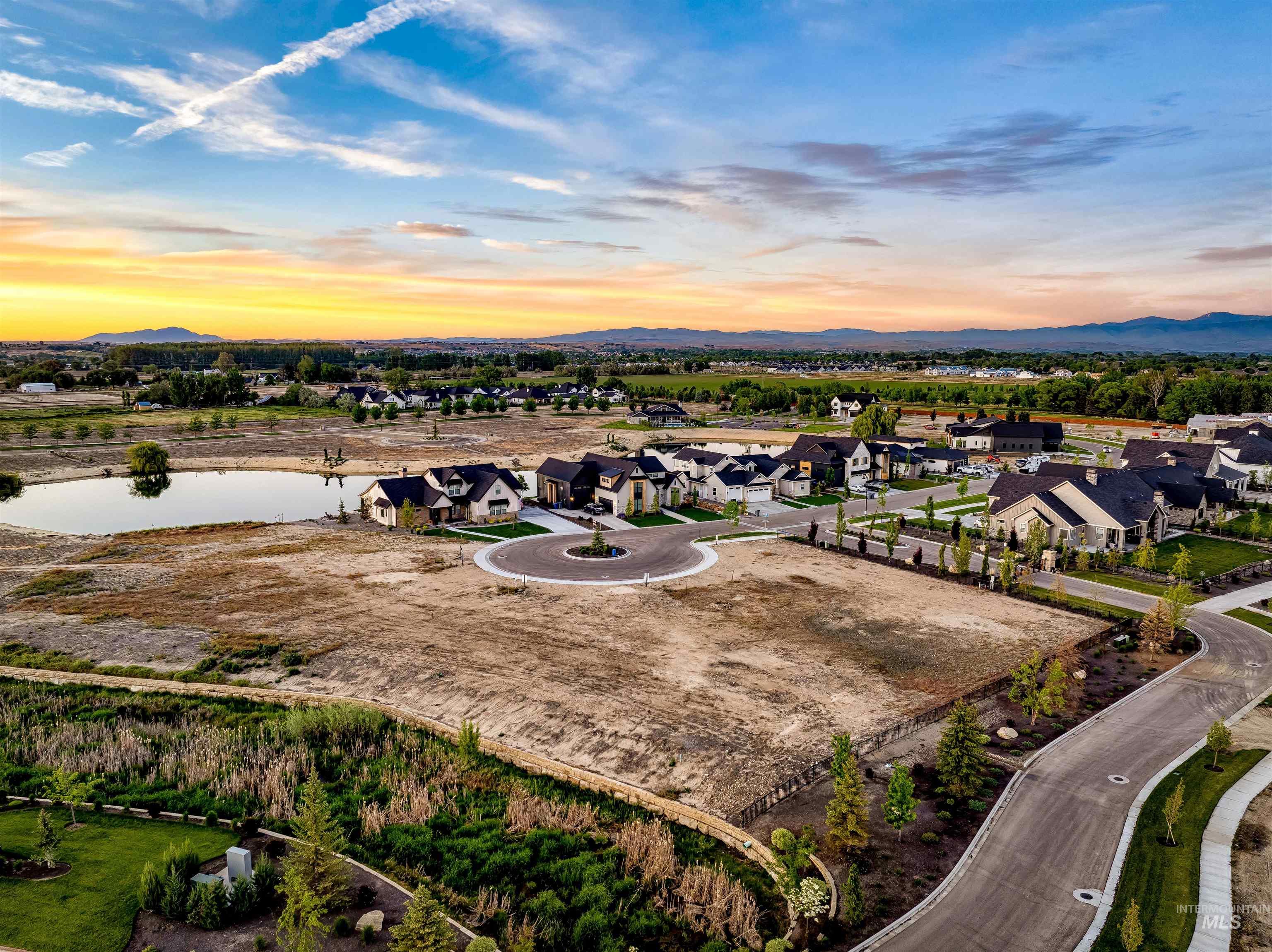 Aerial view at dusk of a residential view and a water and mountain view