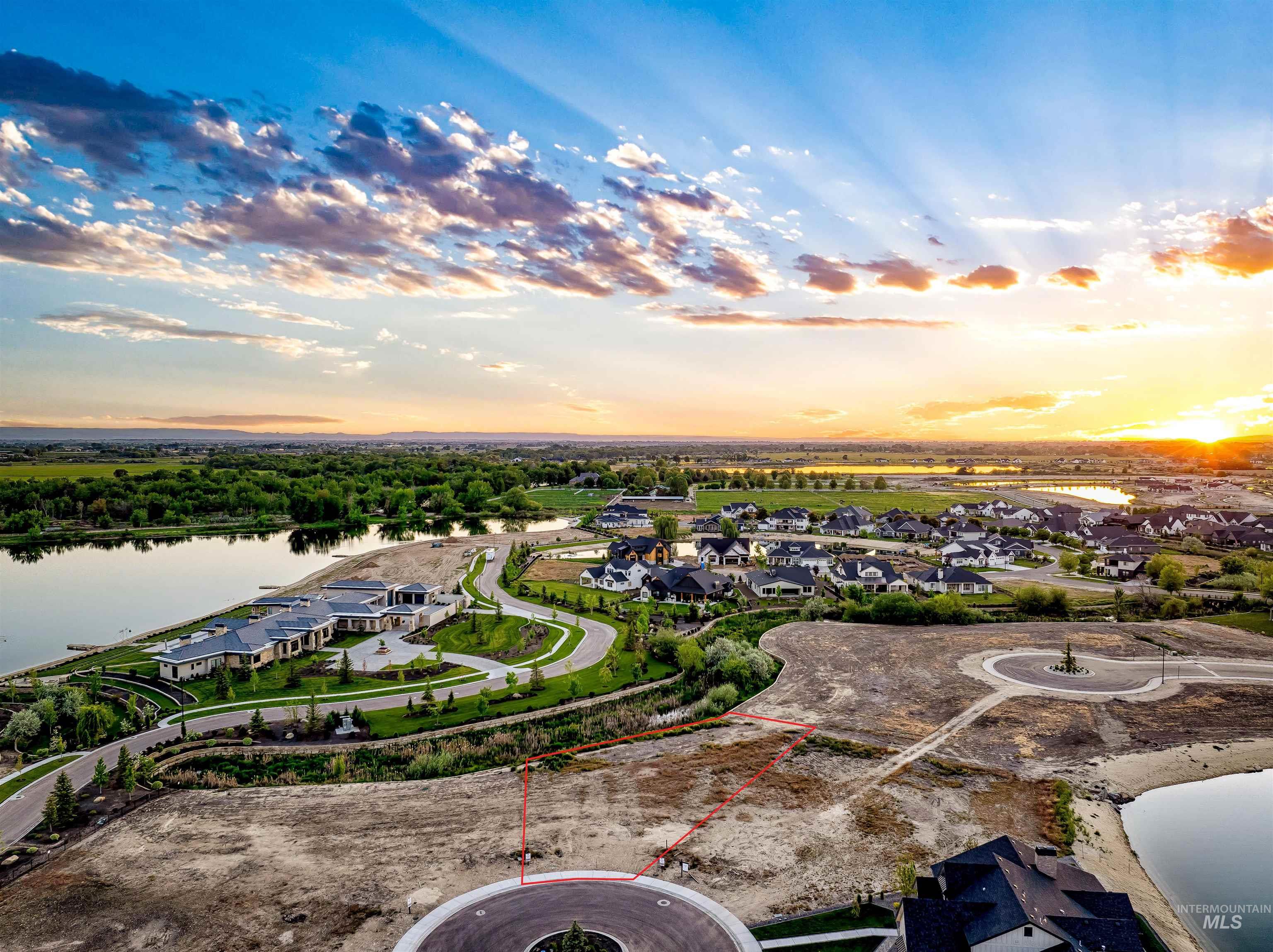 Aerial perspective of suburban area featuring a nearby body of water and property parcel outlined