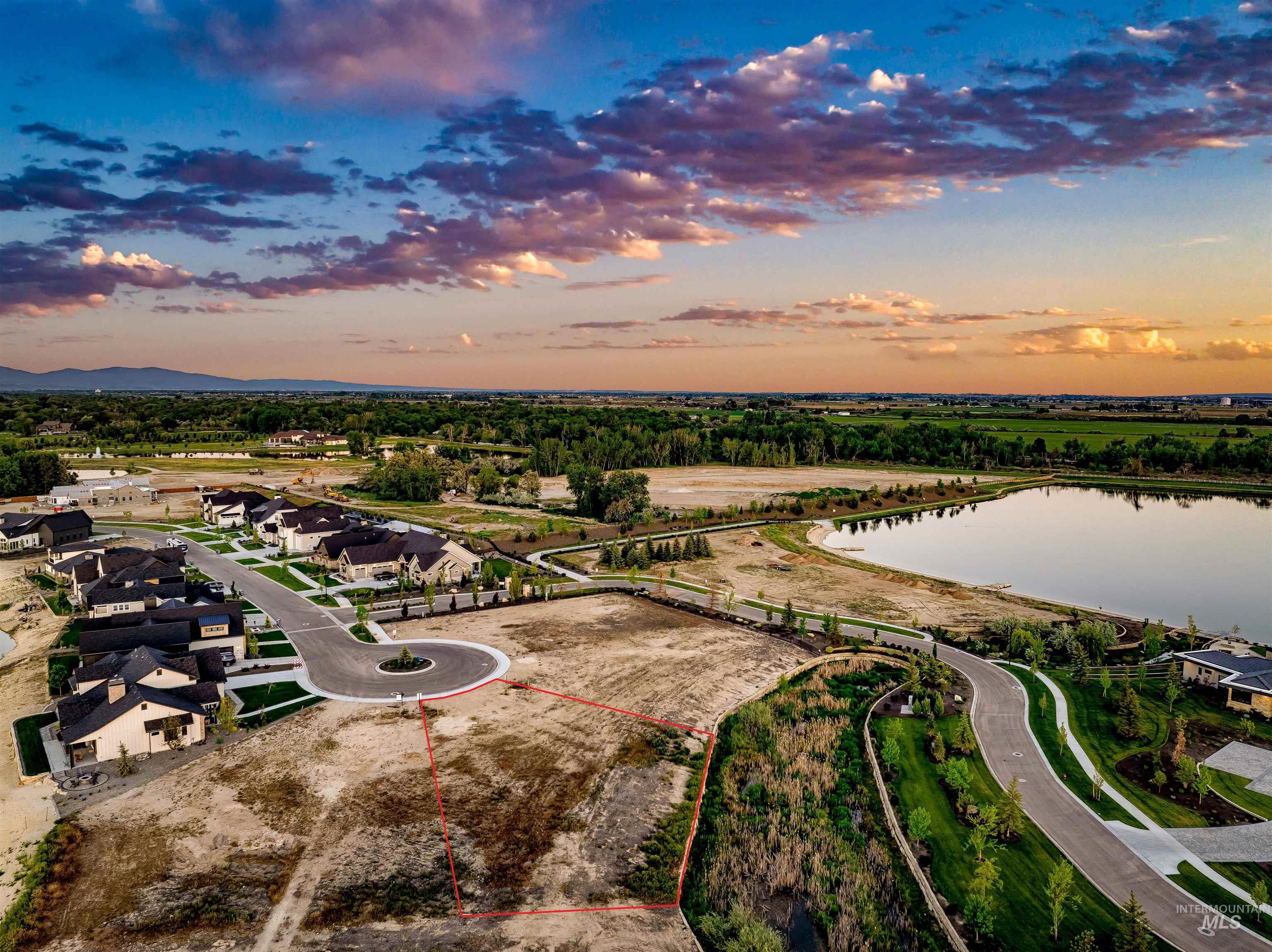 Aerial view of residential area featuring a nearby body of water and property boundaries highlighted