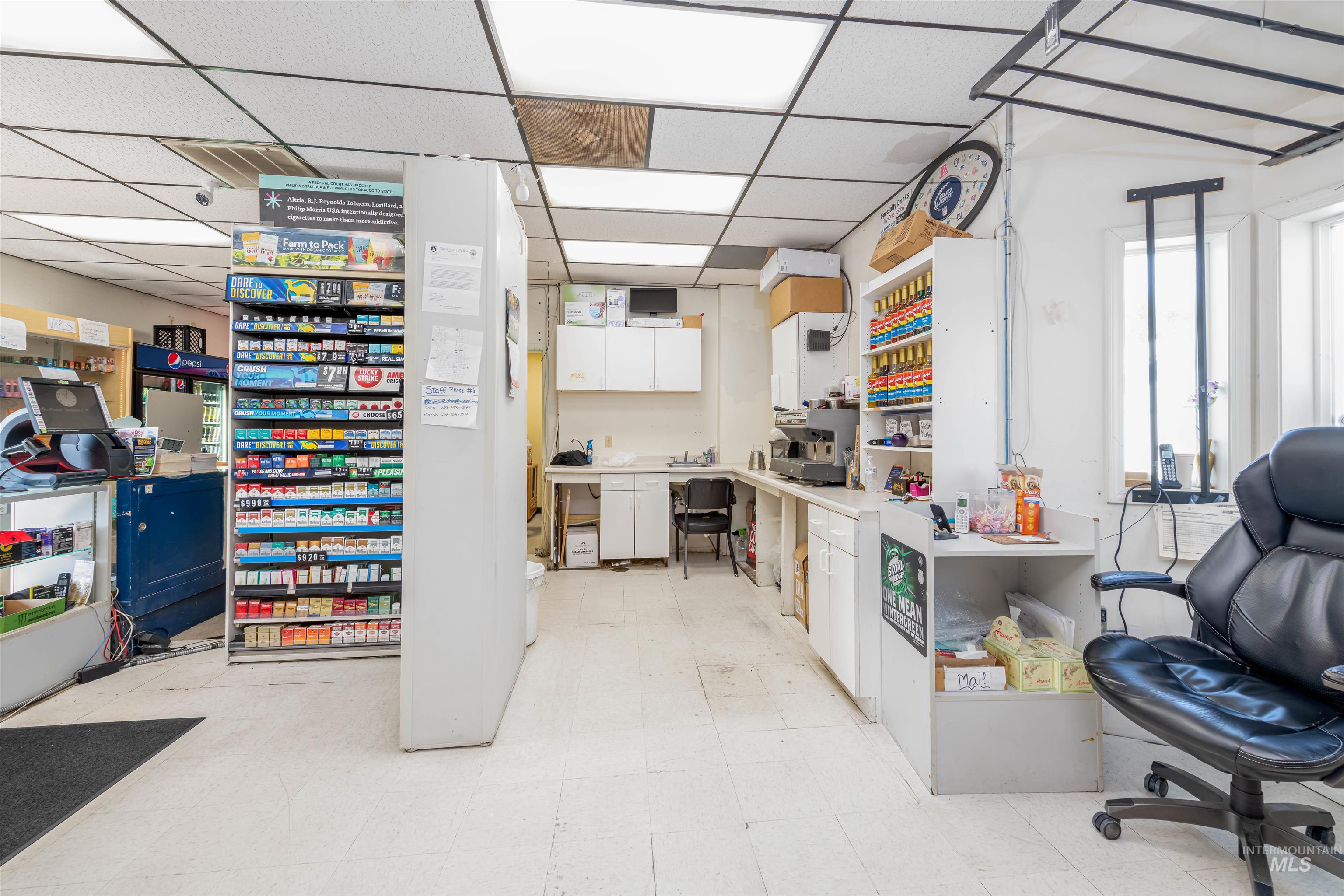 Kitchen featuring white cabinets, light countertops, and a drop ceiling