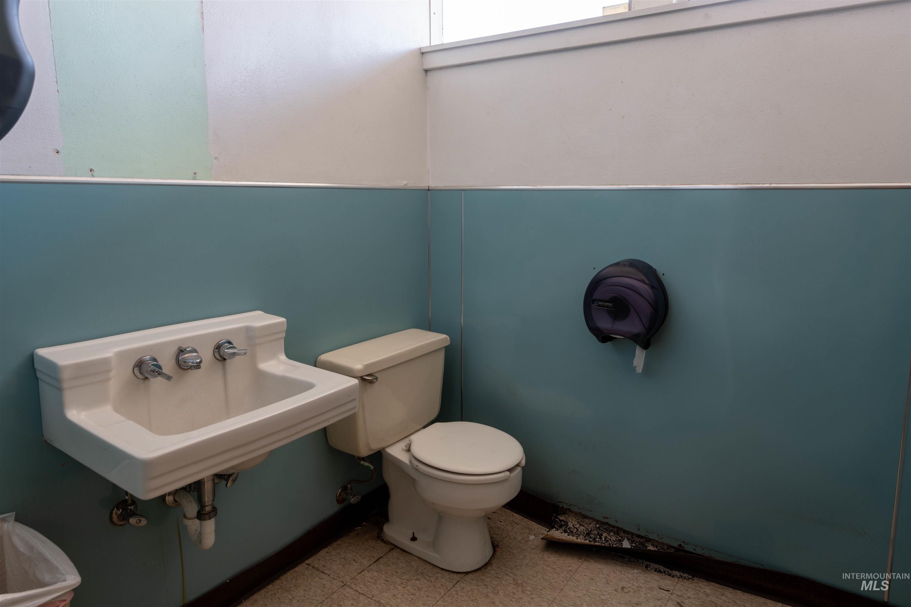 Half bath featuring toilet and tile patterned floors