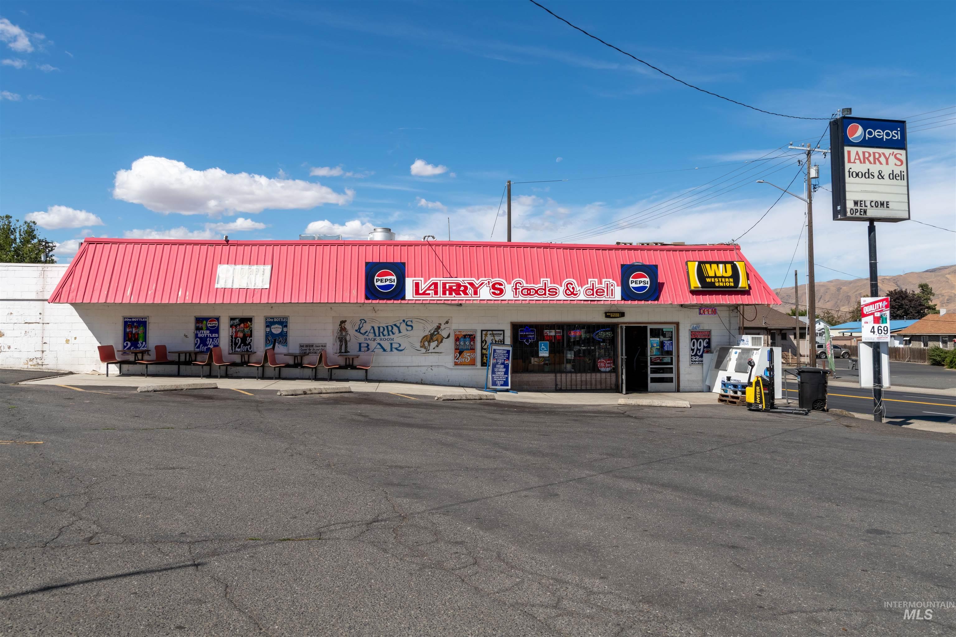 View of commercial property with uncovered parking