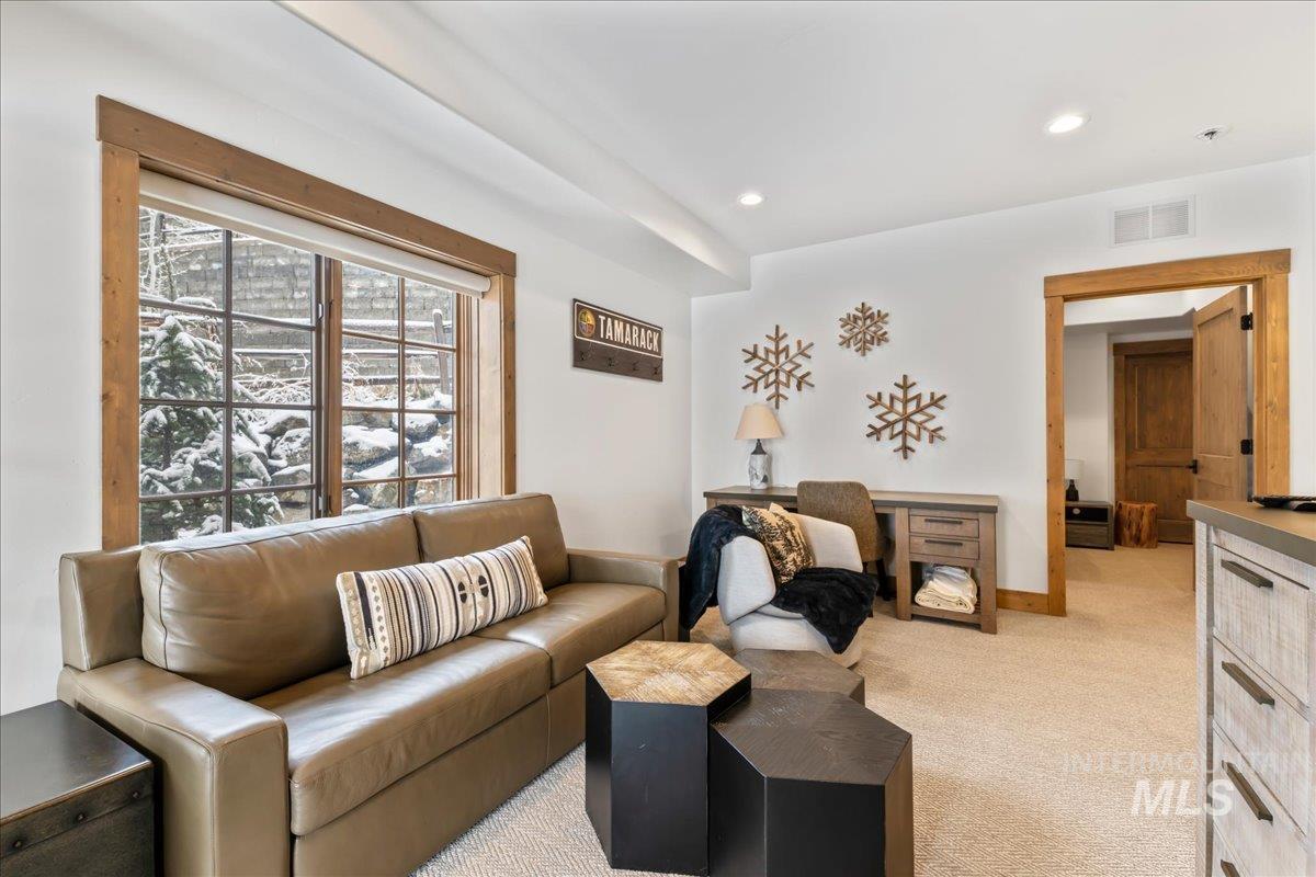 Living room featuring light carpet and recessed lighting