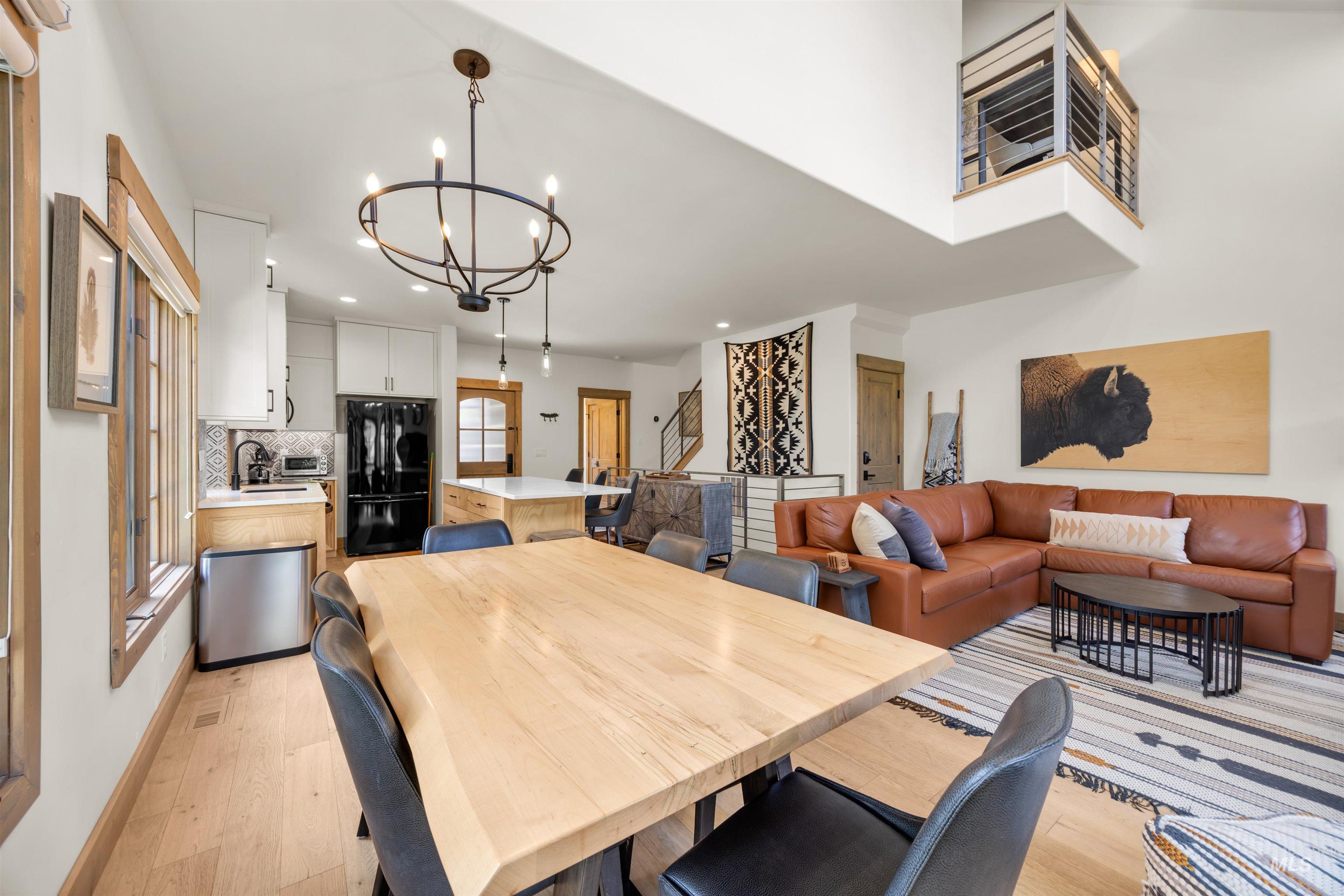 Expansive open-concept living space featuring high ceilings and light wood-finish flooring