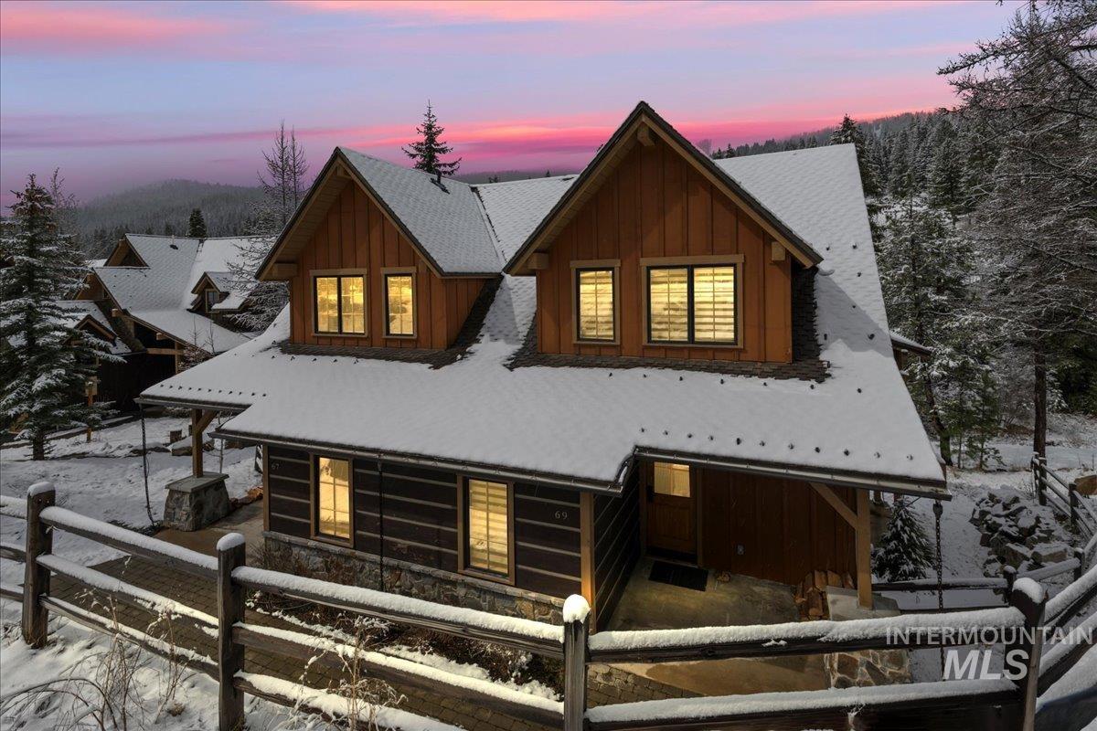 View of front facade featuring board and batten siding and a porch