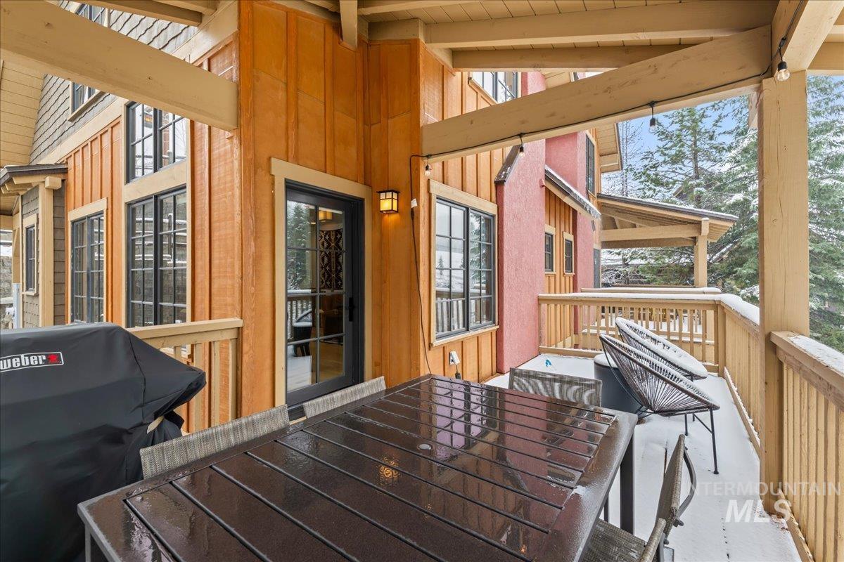 Wooden deck with outdoor dining space and area for grilling