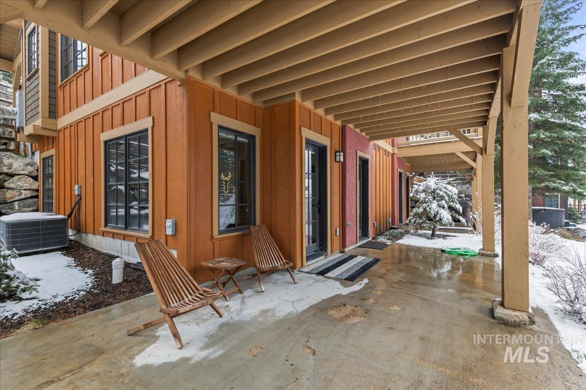 Snow covered patio featuring a patio