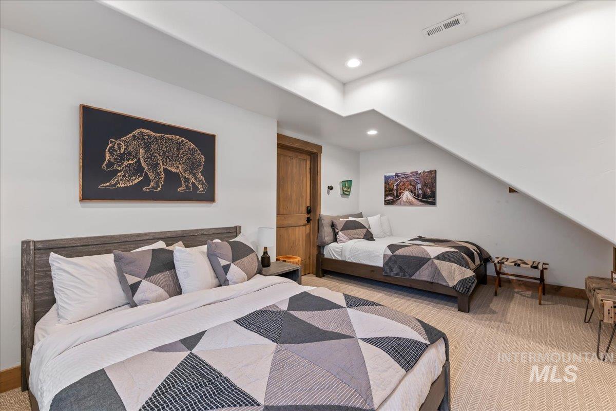 Bedroom featuring light colored carpet and recessed lighting