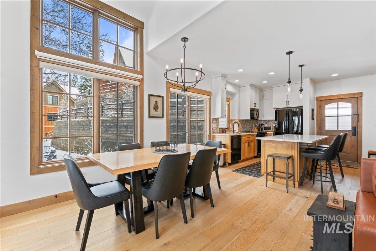 Dining space featuring light wood finished floors and a chandelier