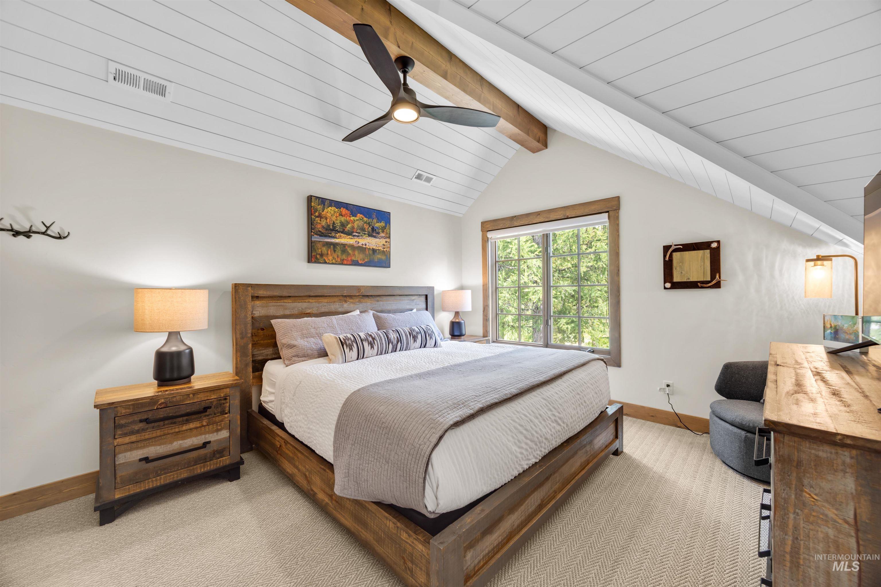 Vaulted ceiling featuring shiplap and exposed wood beams