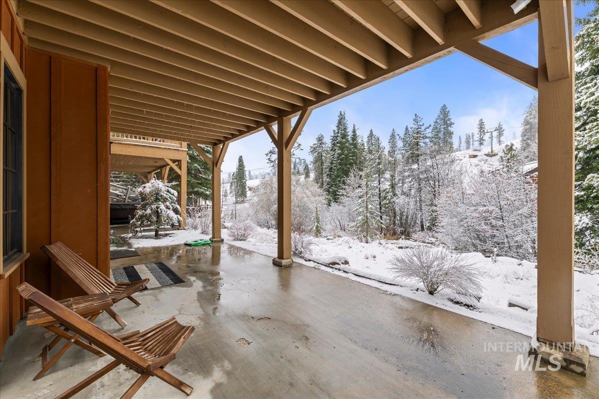 Snow covered patio featuring a patio