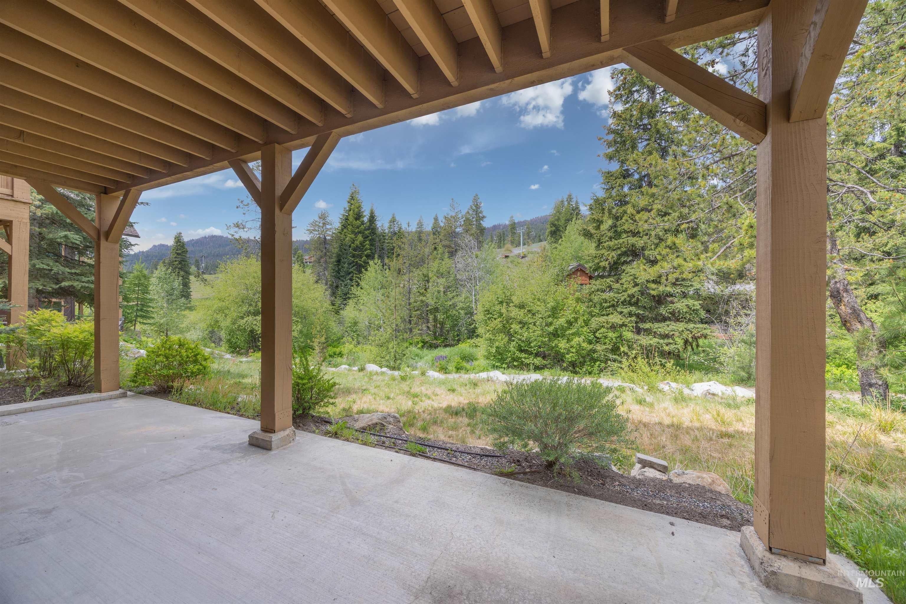 Covered patio featuring a concrete surface and substantial wood pillars