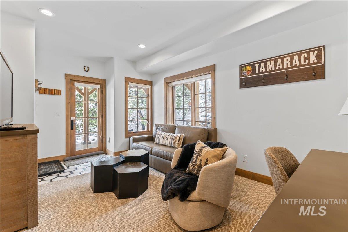 Living room with light colored carpet and recessed lighting