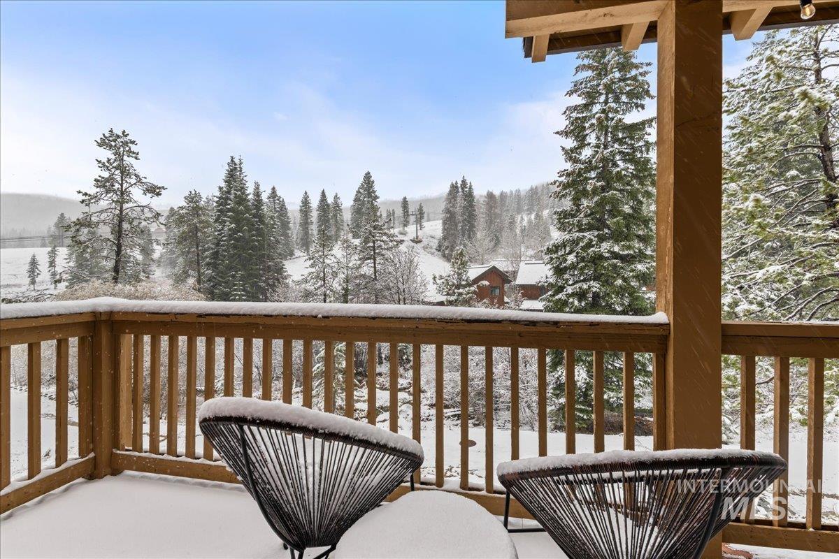 Snow covered deck with a balcony
