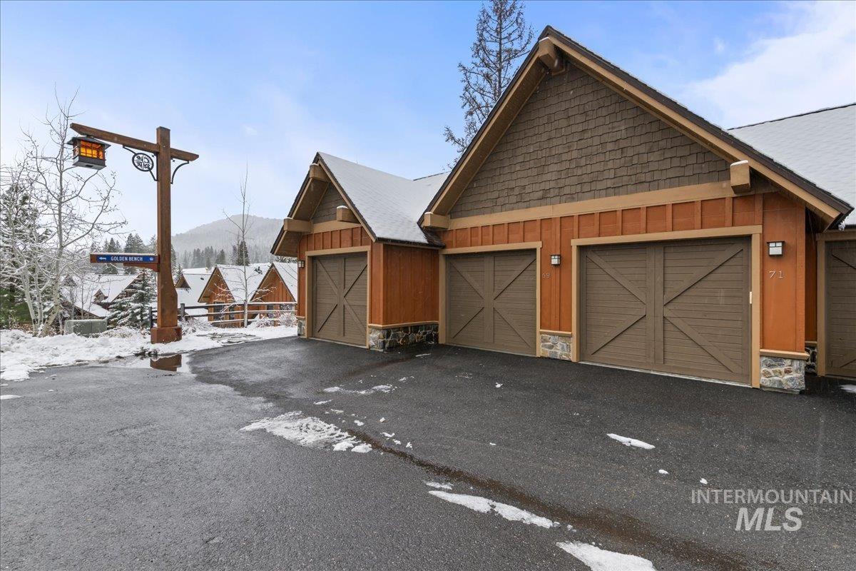 View of front of home featuring board and batten siding, stone siding, and a mountain view