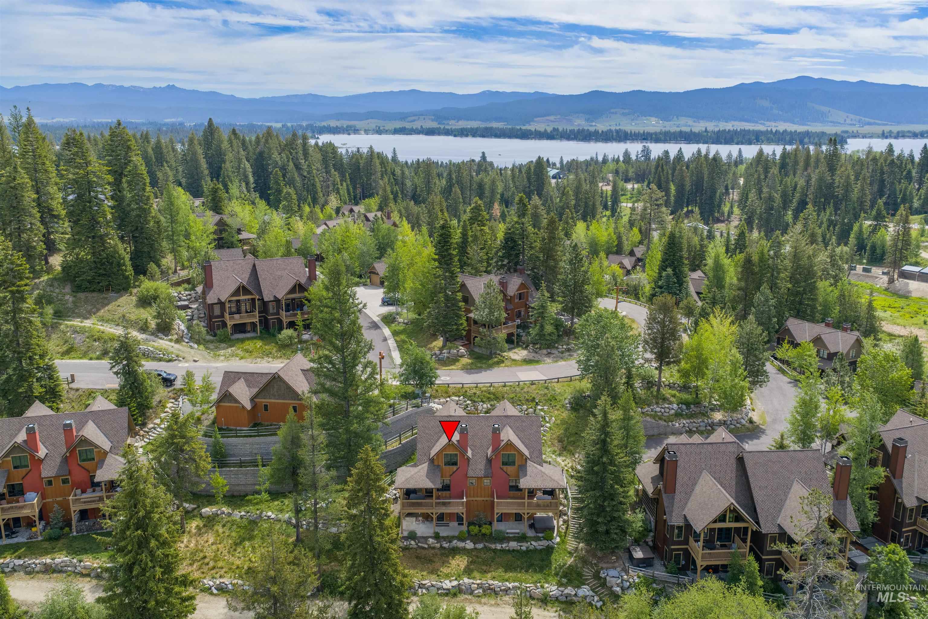 Mountain community featuring a lake and distant mountain range