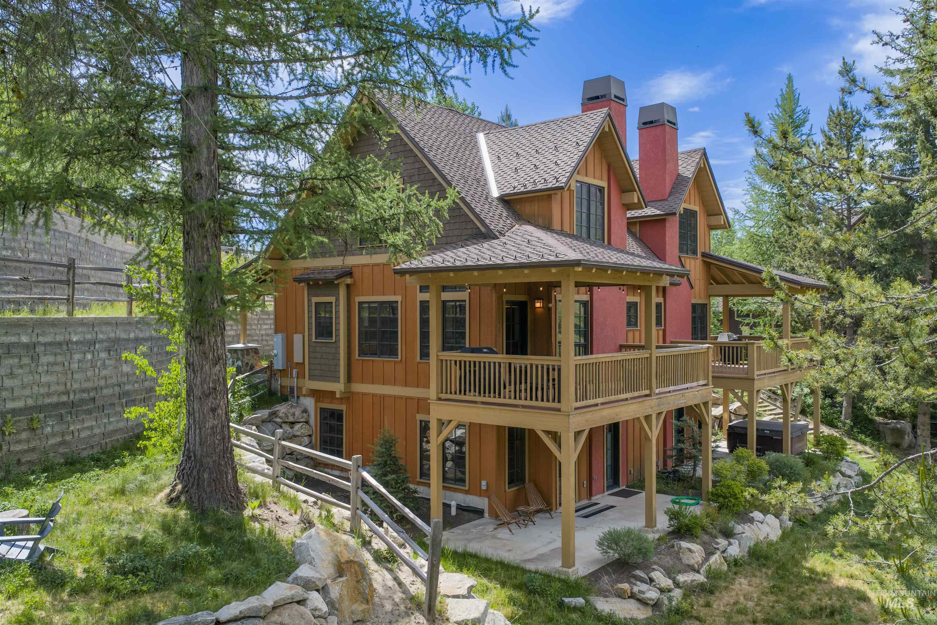 Multi-level residence featuring warm wood siding and a brown shingle roof
