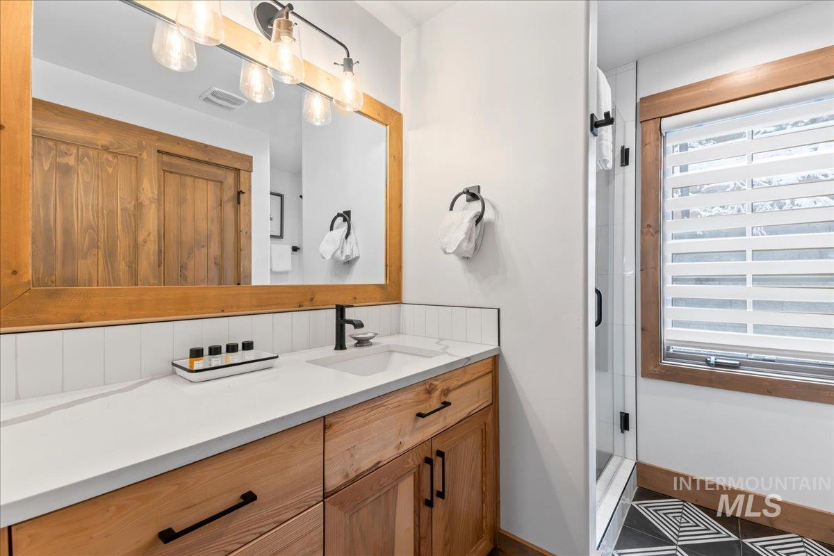 Bathroom featuring vanity and a shower stall