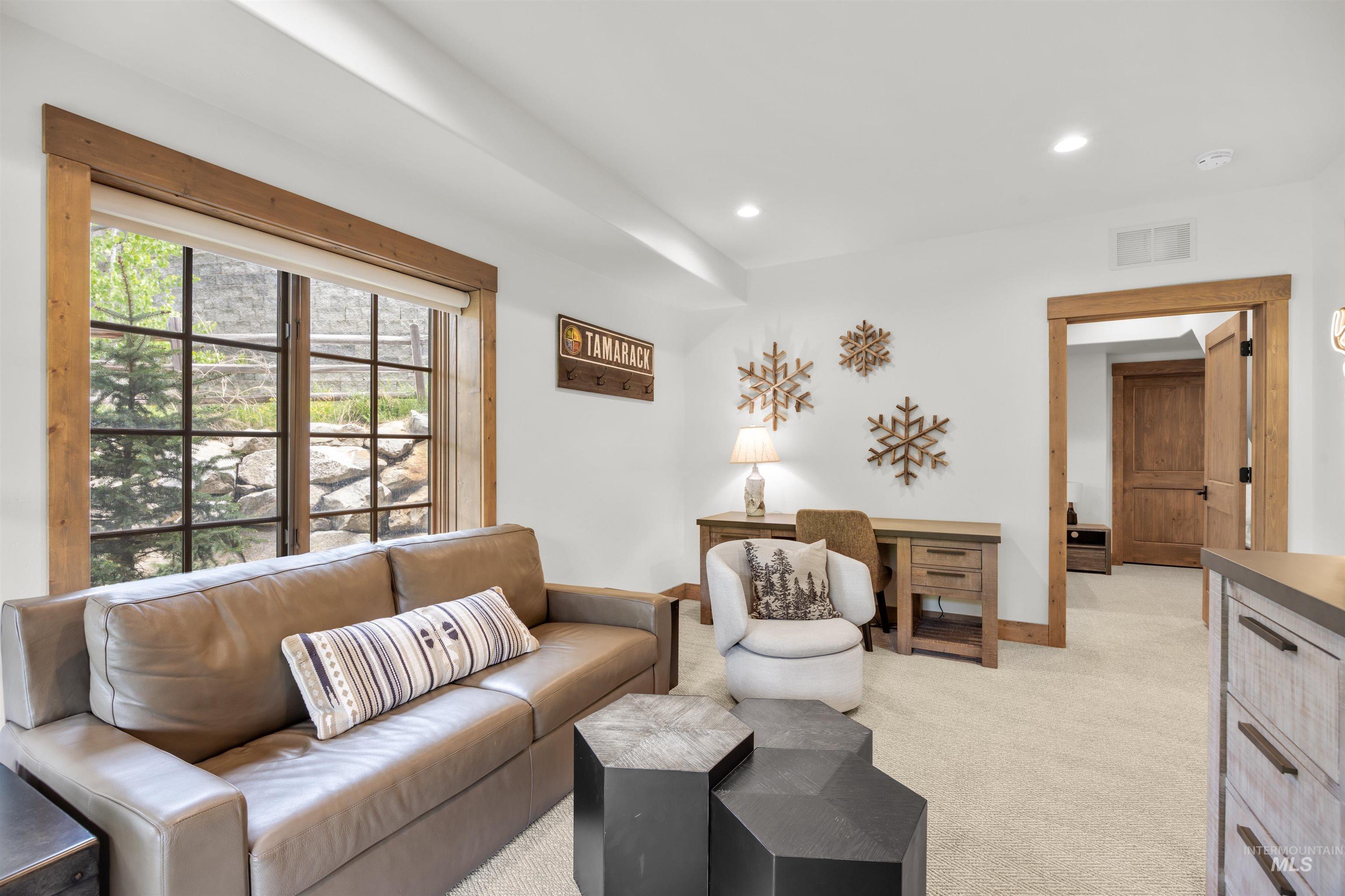 Spacious room featuring a large grid-pattern window with wood trim