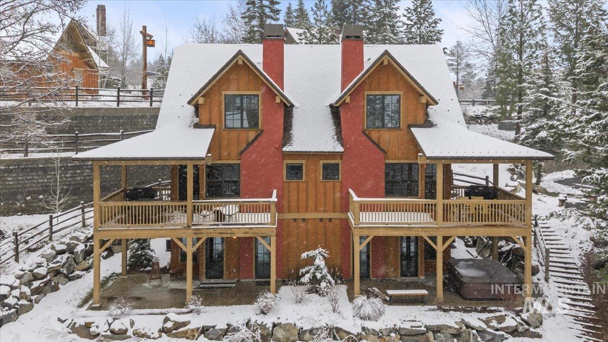 Snow covered property with a patio, a chimney, a deck, and a gazebo