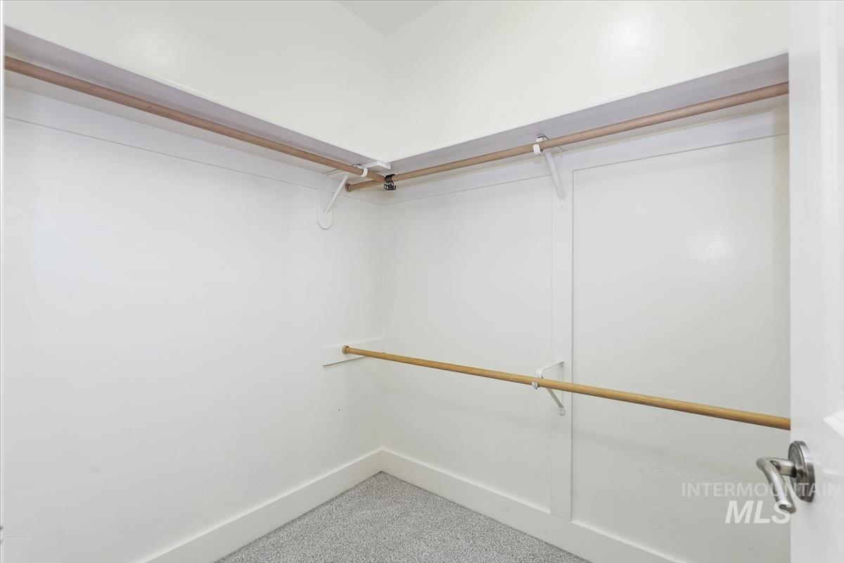 Spacious closet with carpet floors