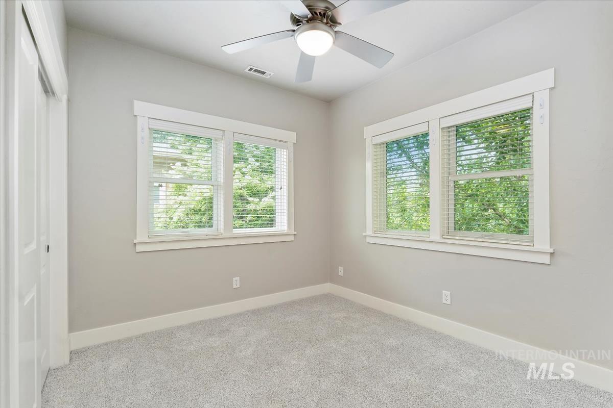 Unfurnished bedroom featuring carpet floors, ceiling fan, and a closet