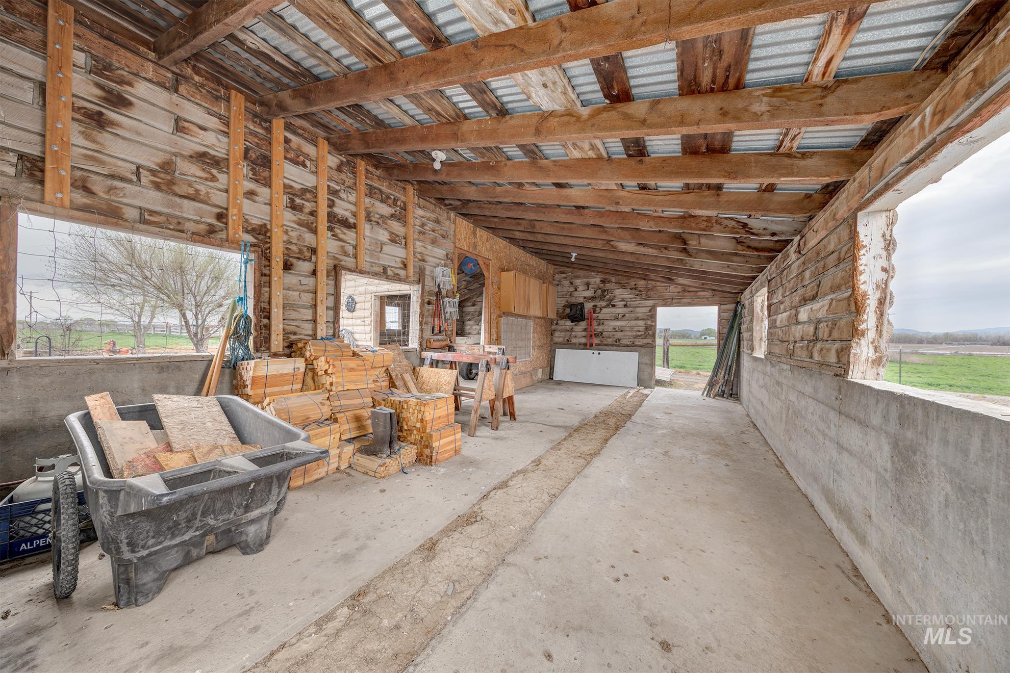 Misc room with vaulted ceiling and concrete floors