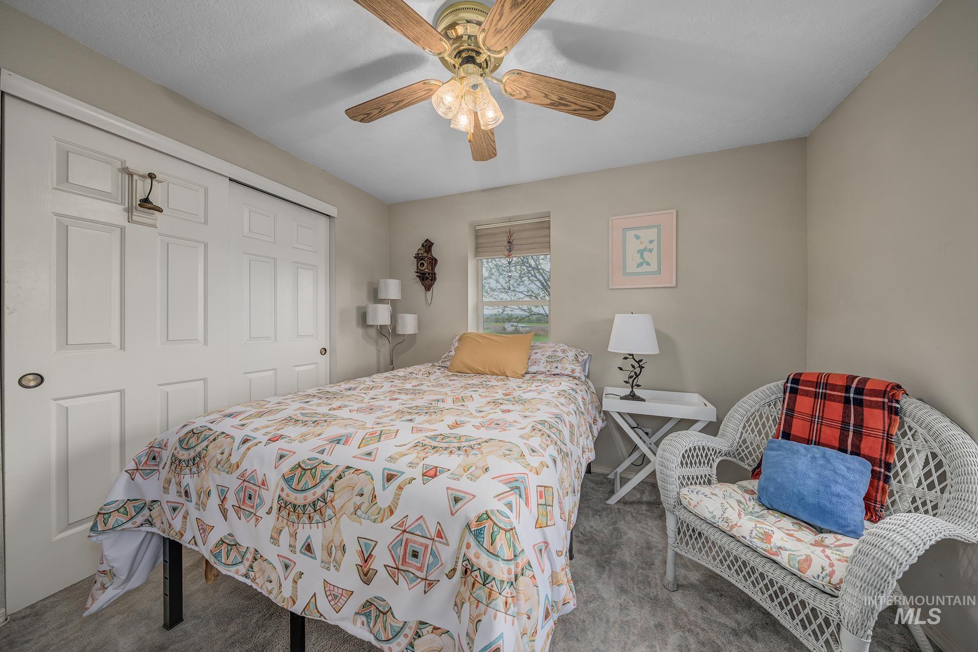 Bedroom featuring a closet, carpet flooring, and ceiling fan