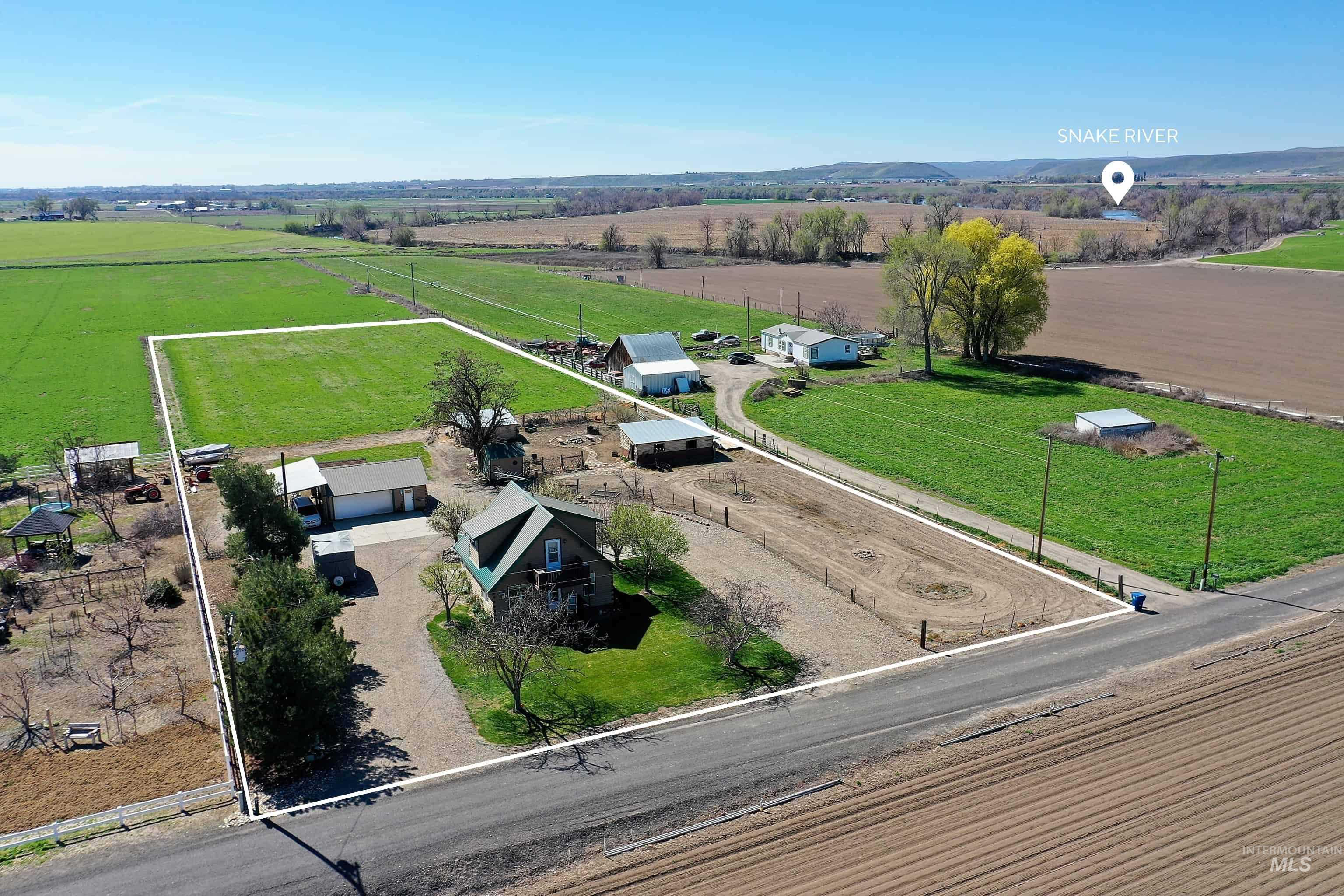 Aerial view of sparsely populated area with property parcel outlined