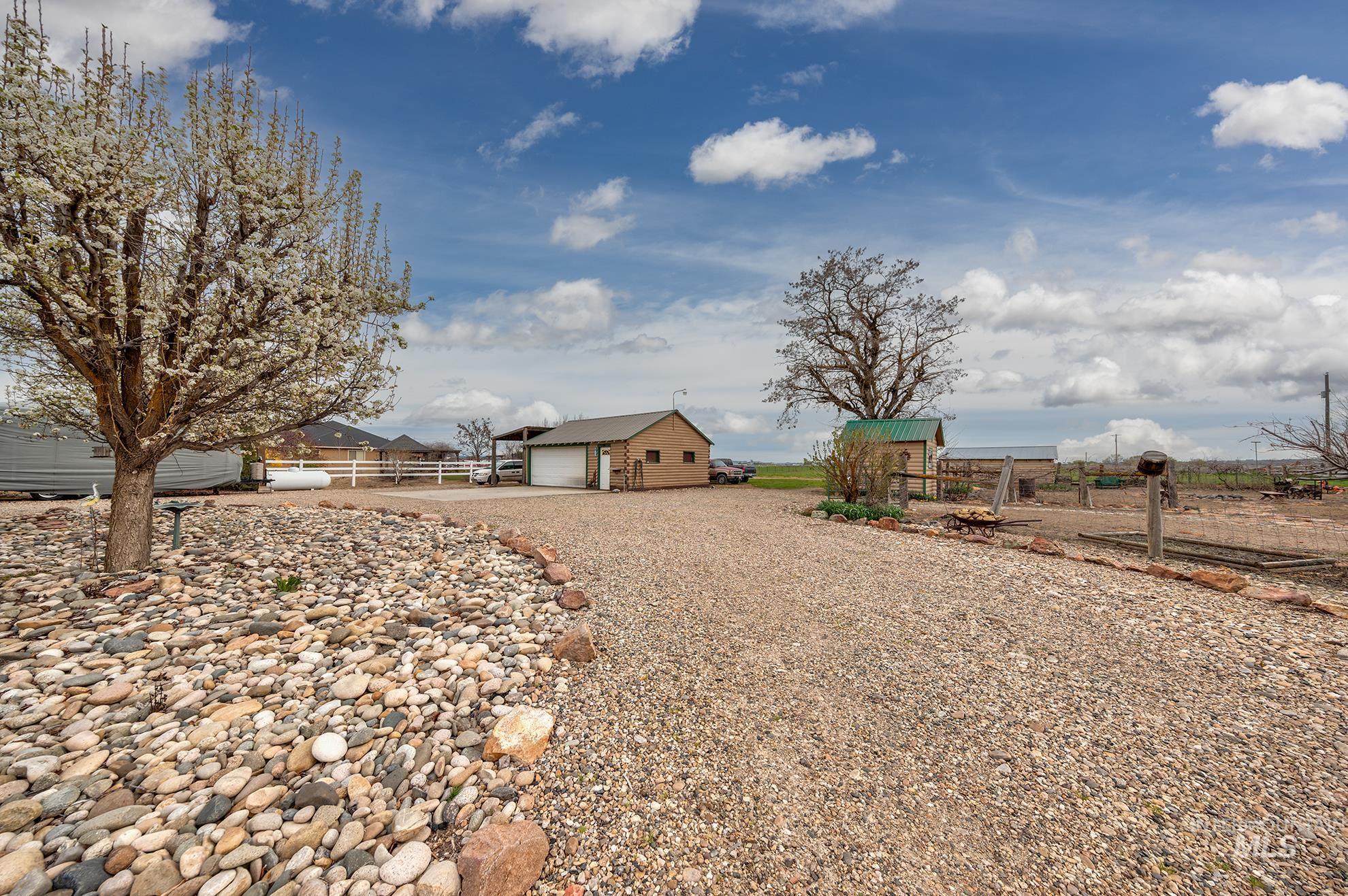 View of yard with an outbuilding and gravel driveway