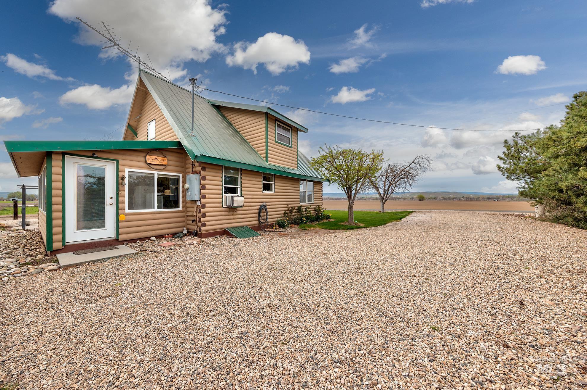 Back of property featuring log siding and a metal roof