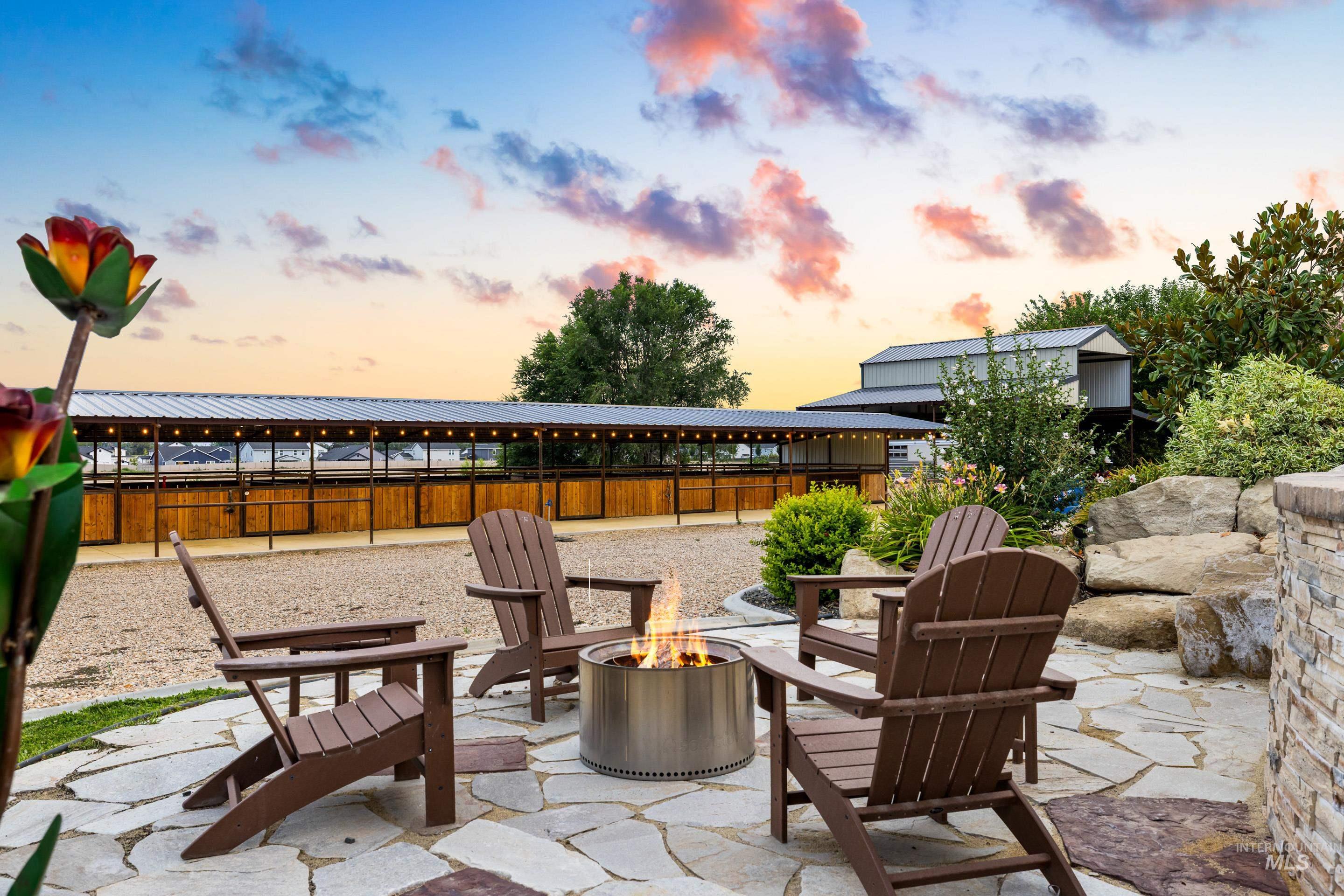Patio terrace at dusk featuring an outdoor fire pit and a patio area