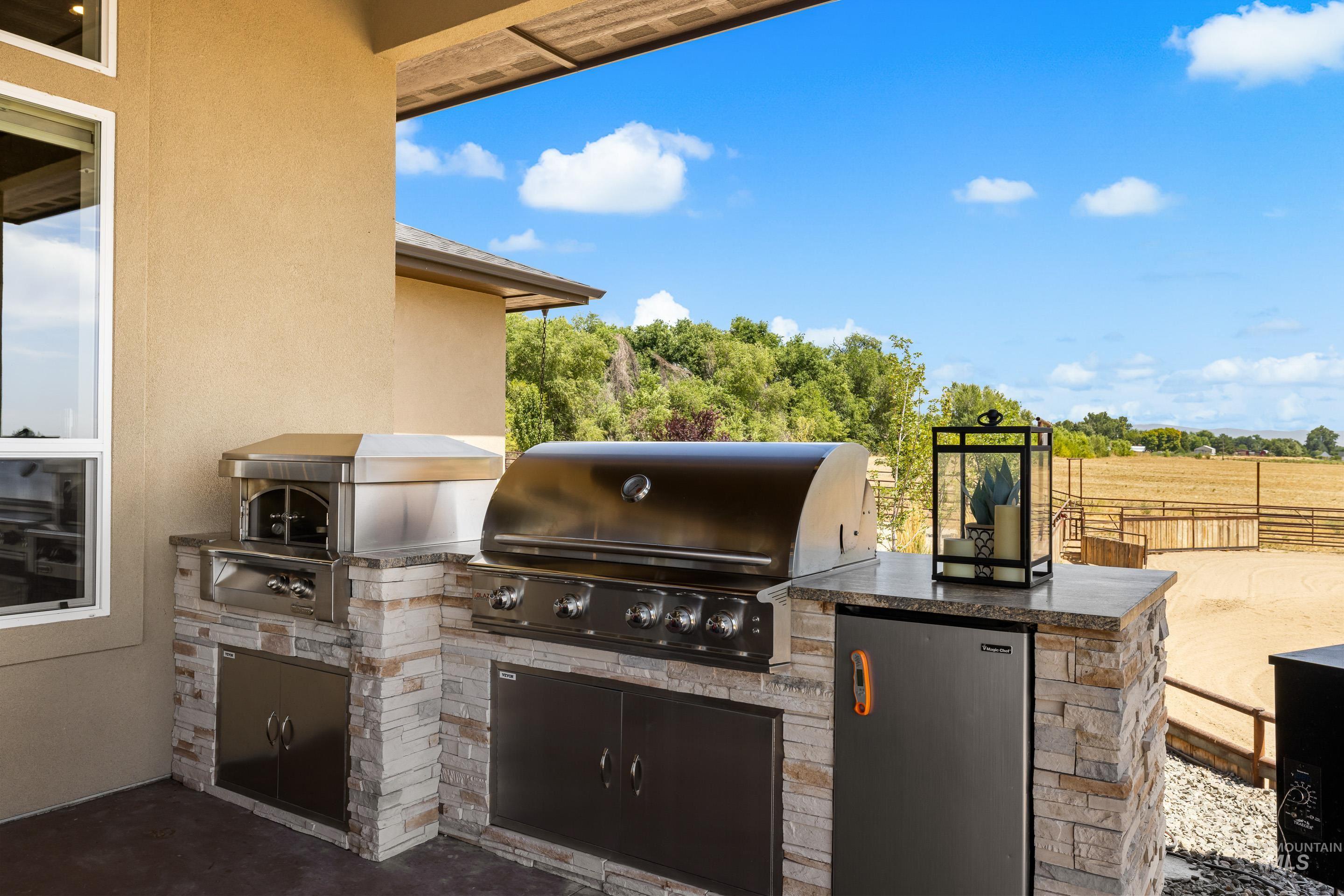 View of patio / terrace with an outdoor kitchen and a garage