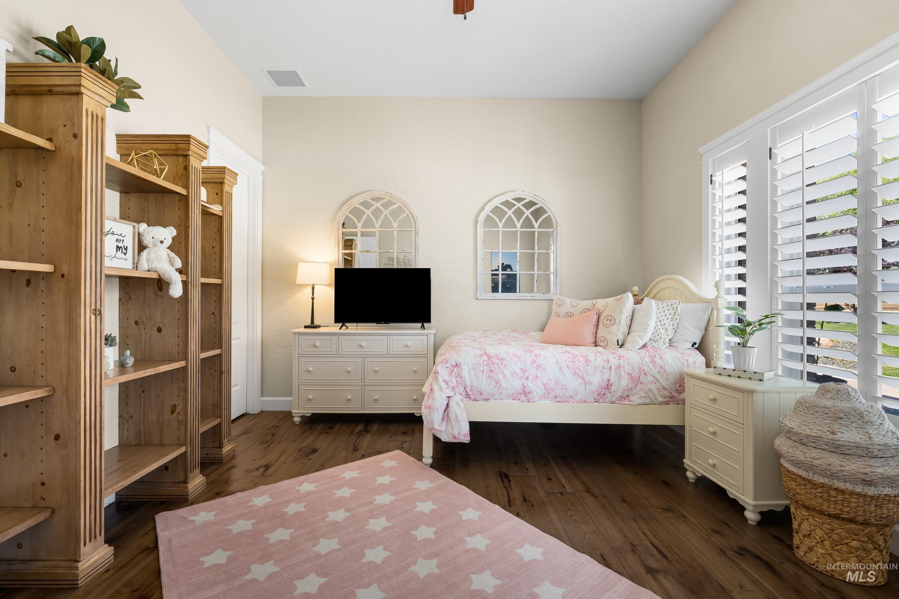 Bedroom featuring dark wood-style flooring and ceiling fan