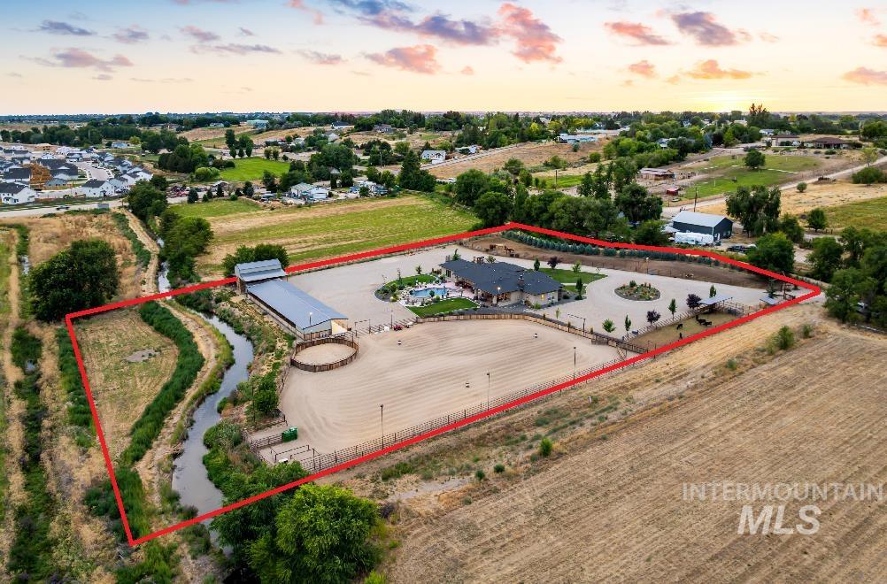 Aerial view at dusk of property boundaries highlighted and a view of countryside