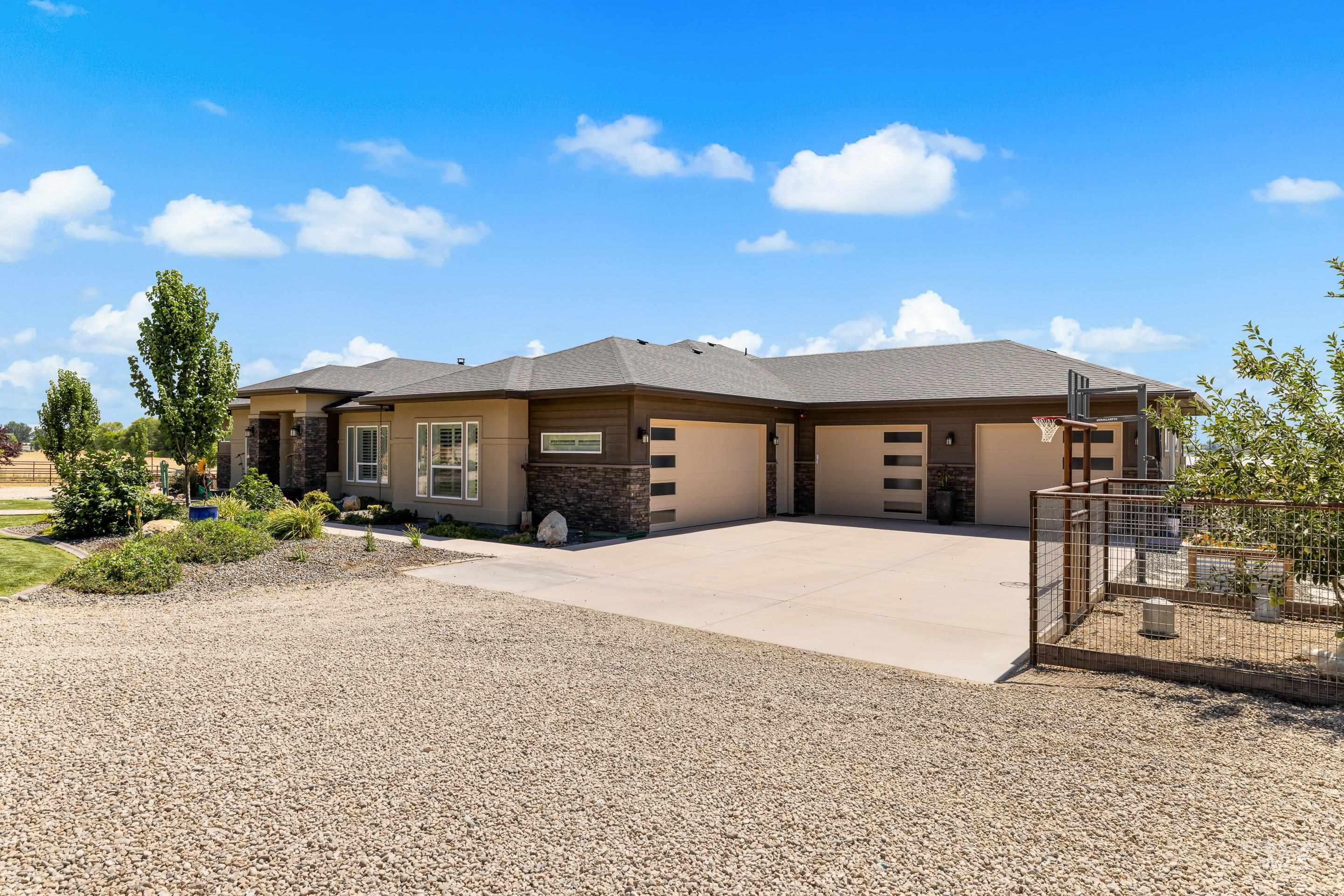Prairie-style house with concrete driveway, a garage, and stone siding