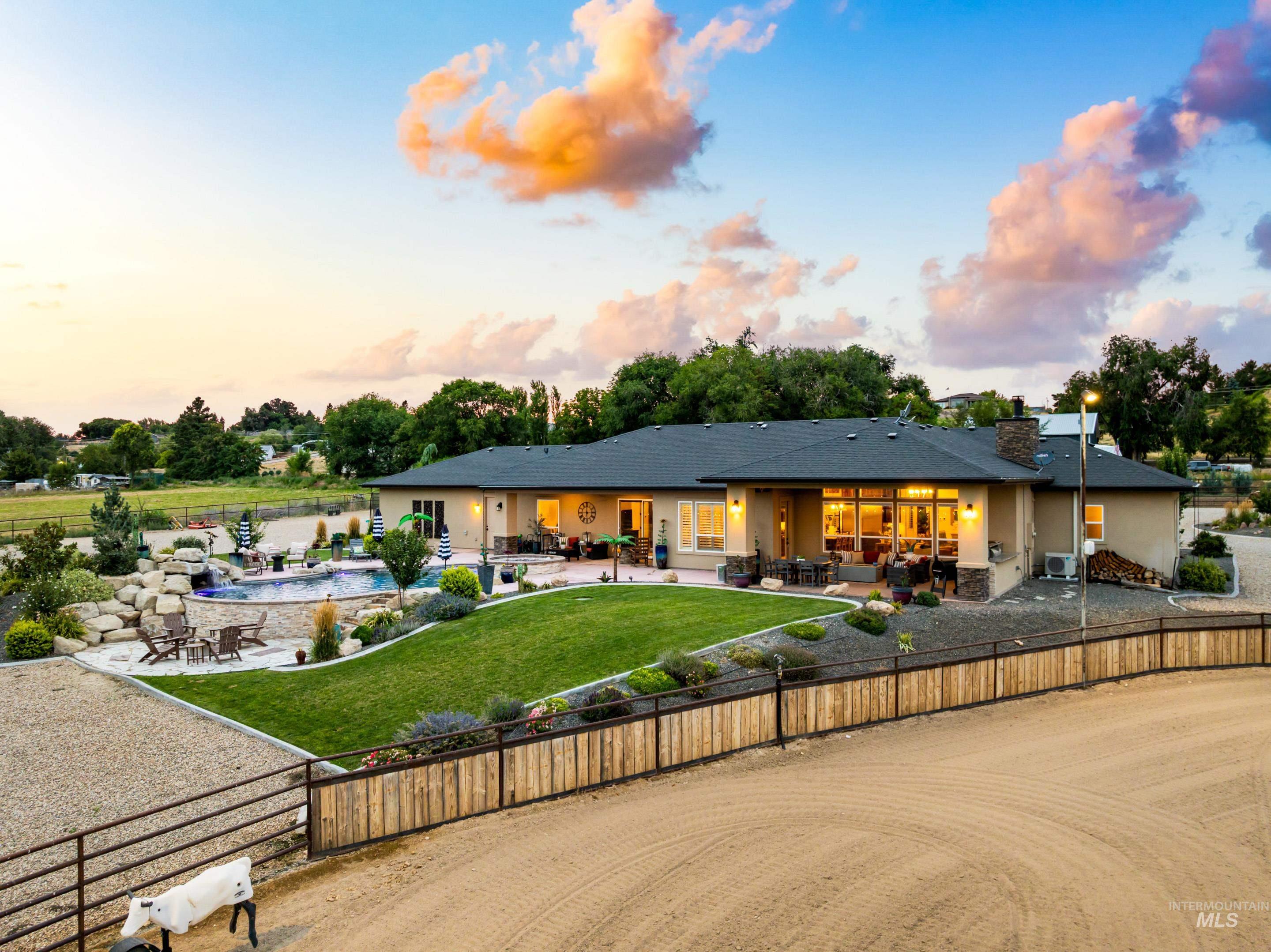 Back of house at dusk with an outdoor living space, a patio area, and stucco siding