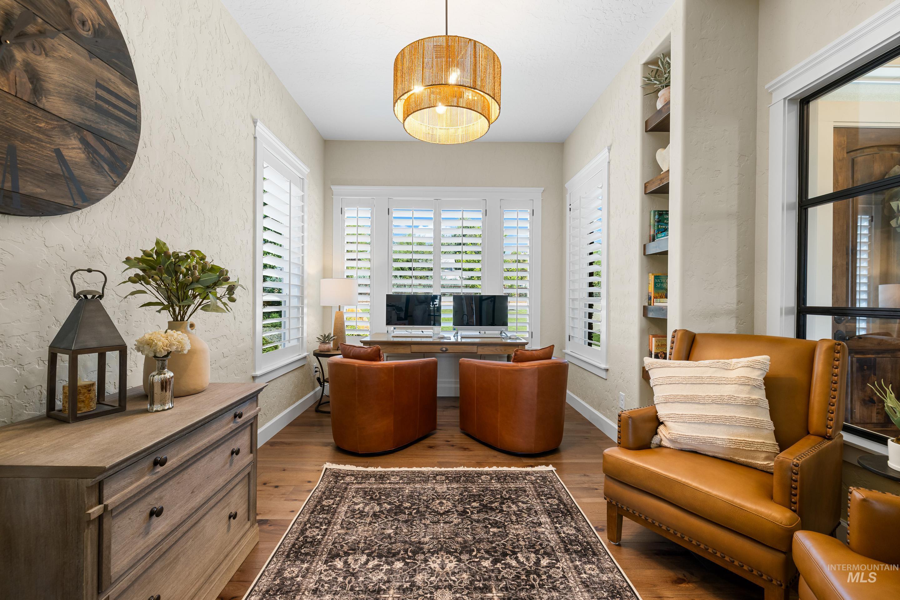 Living area featuring wood finished floors and a textured wall