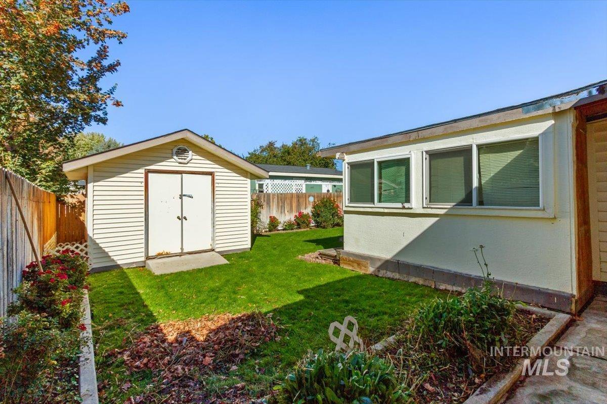 Fenced backyard with a storage unit
