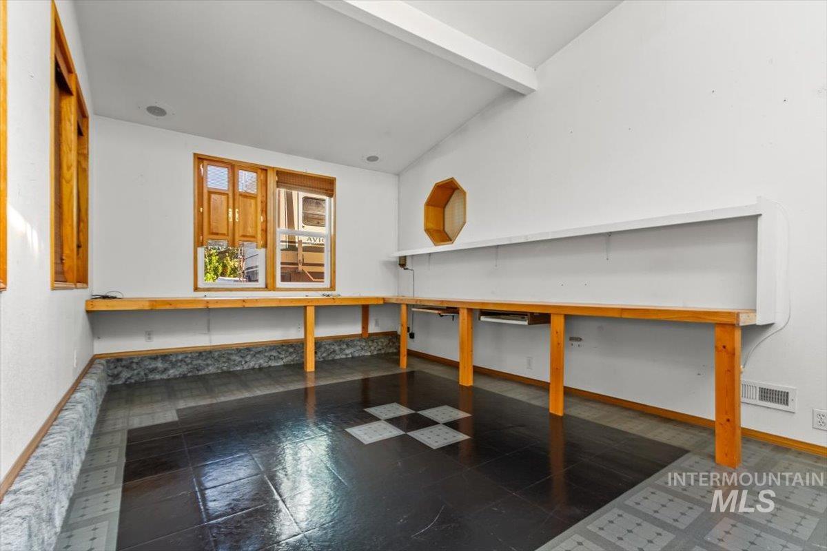 Detailed view of beam ceiling and baseboards