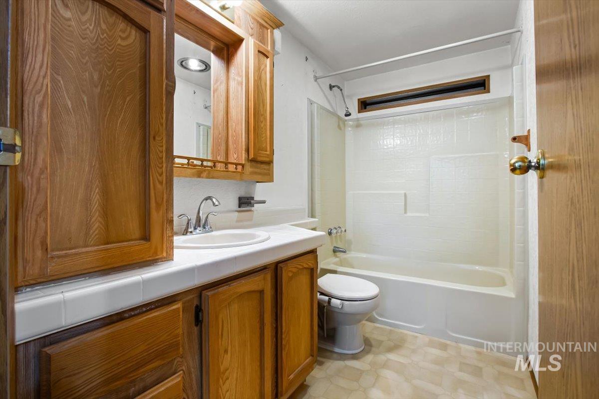 Bathroom featuring shower / bathtub combination and vanity