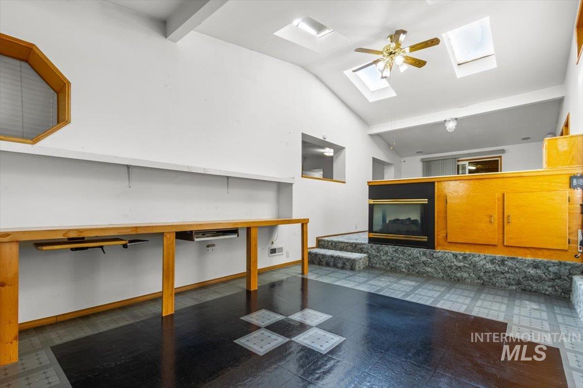 Basement featuring dark floors and baseboards