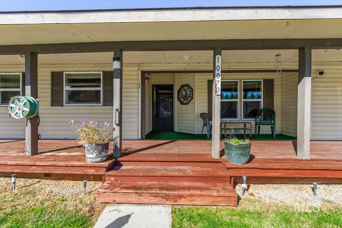 View of exterior entry with a wooden deck
