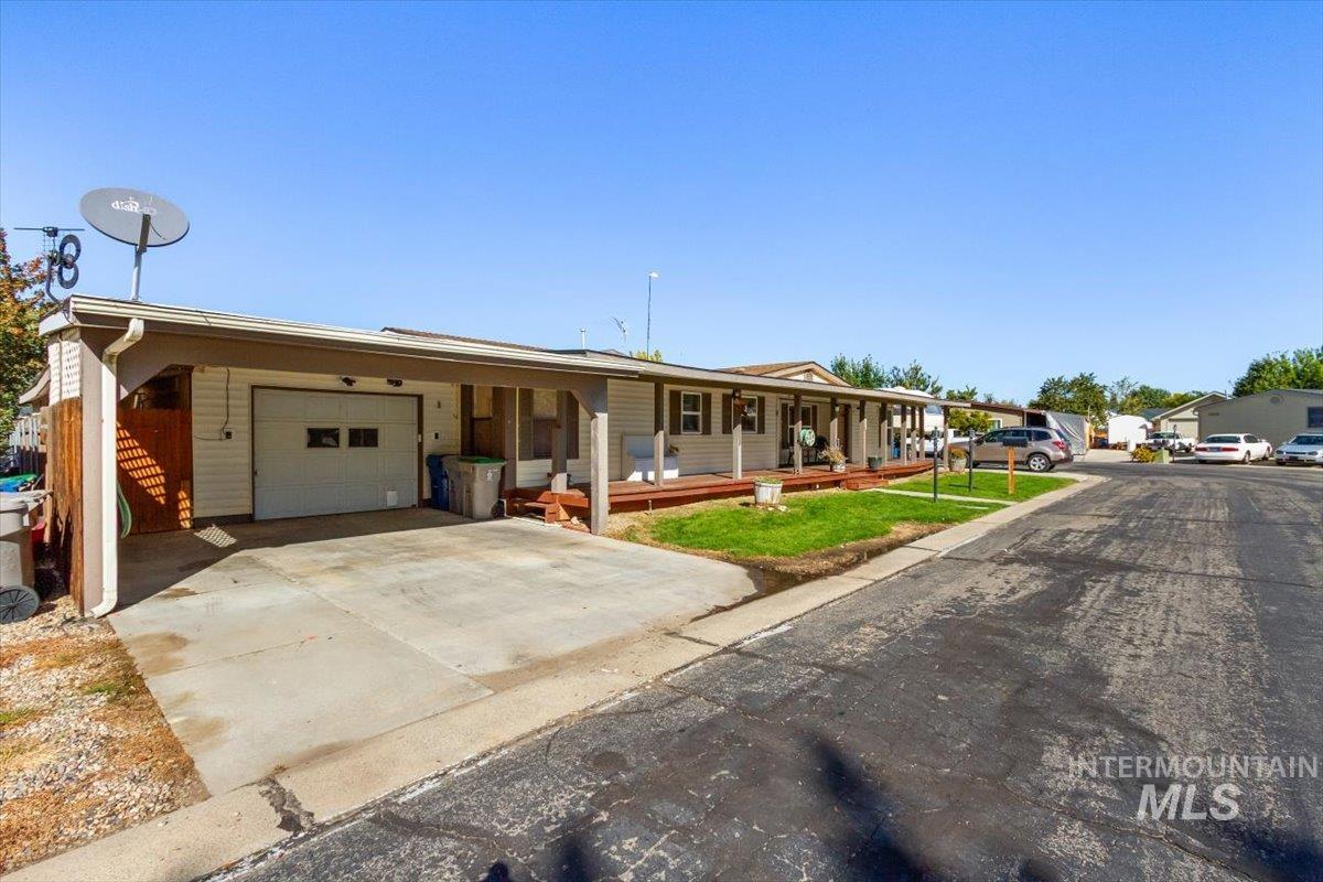 View of front of house with covered porch, an attached garage, and concrete driveway