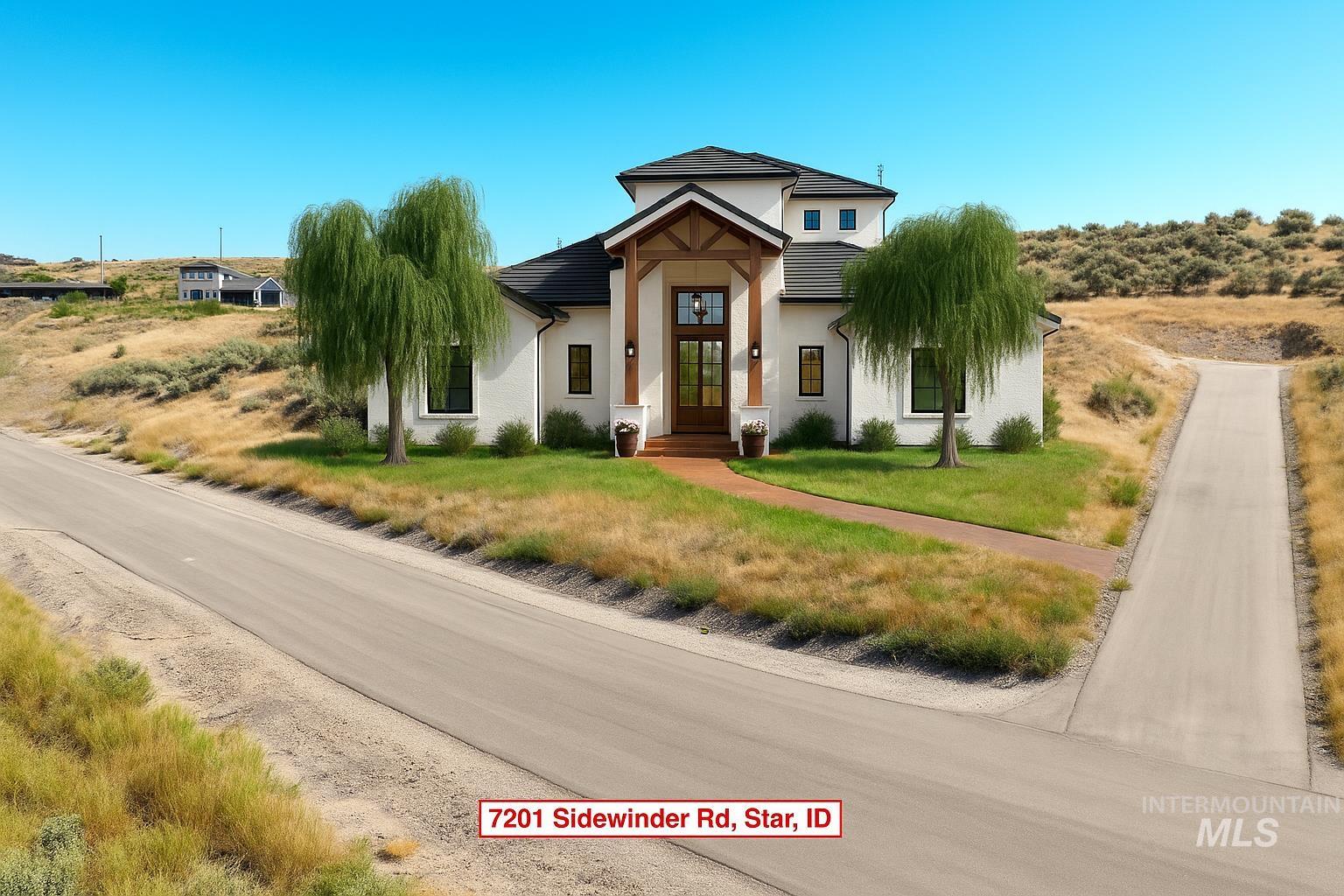 View of front of house featuring stucco siding and a front lawn