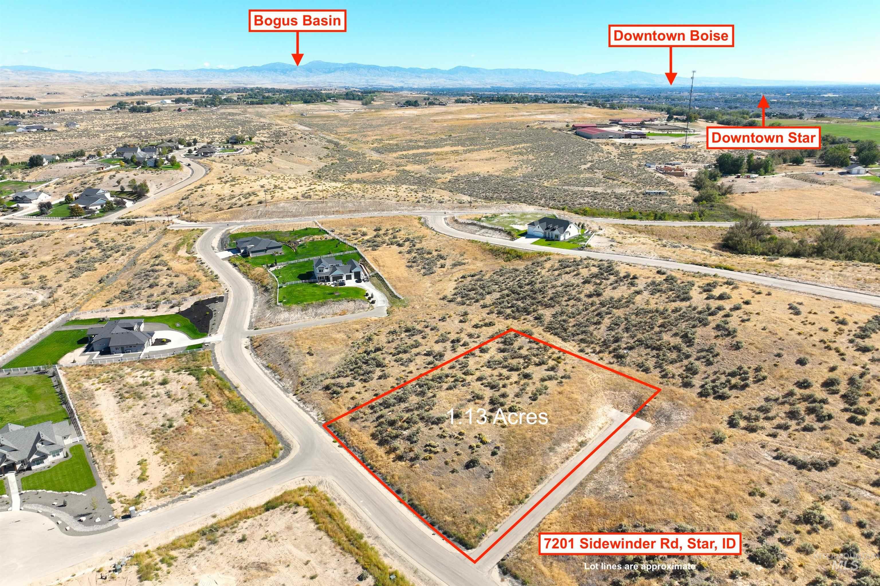 Aerial view of sparsely populated area featuring property boundaries highlighted and a mountainous background