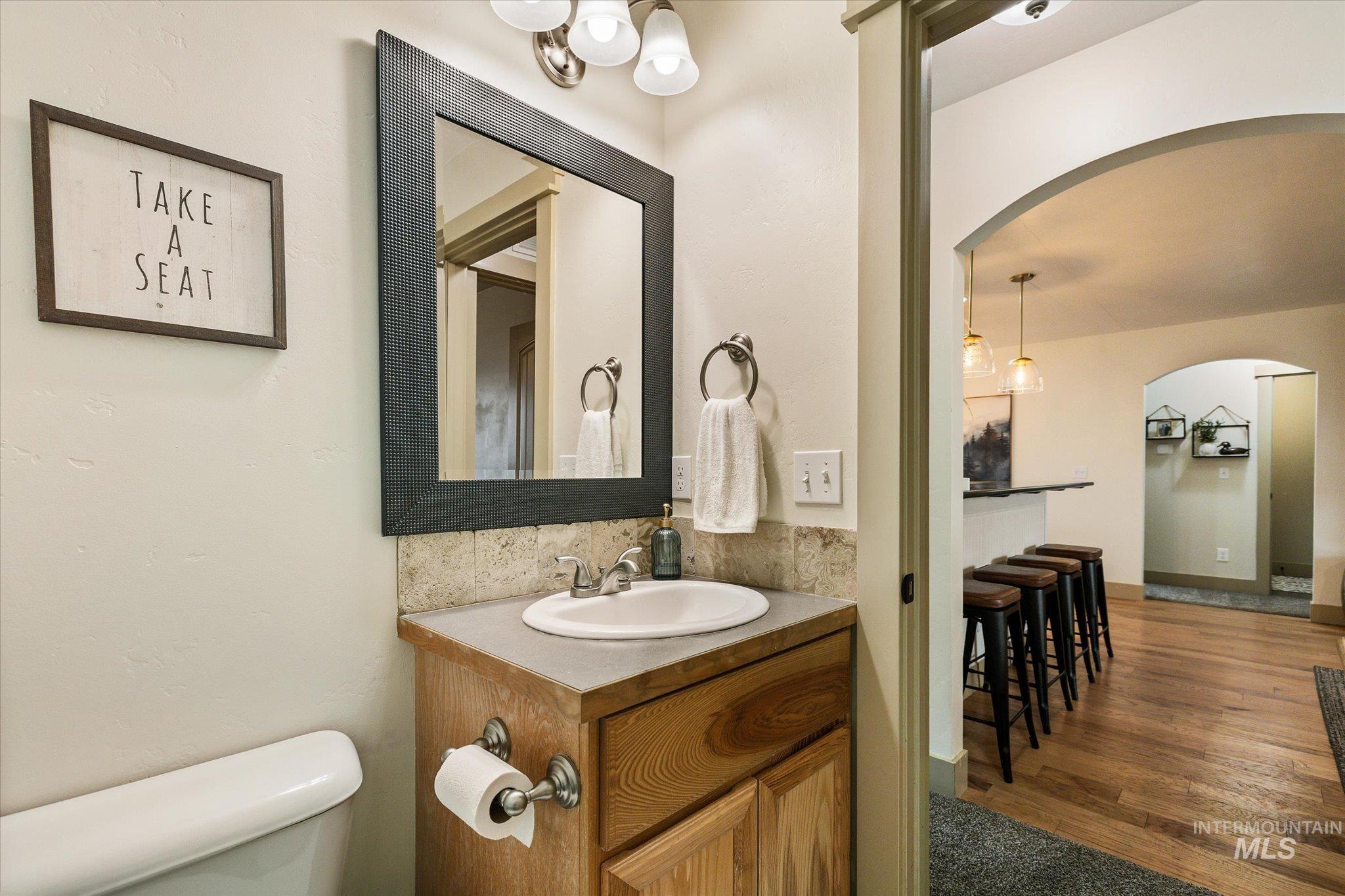 Bathroom featuring vanity and dark wood-style floors