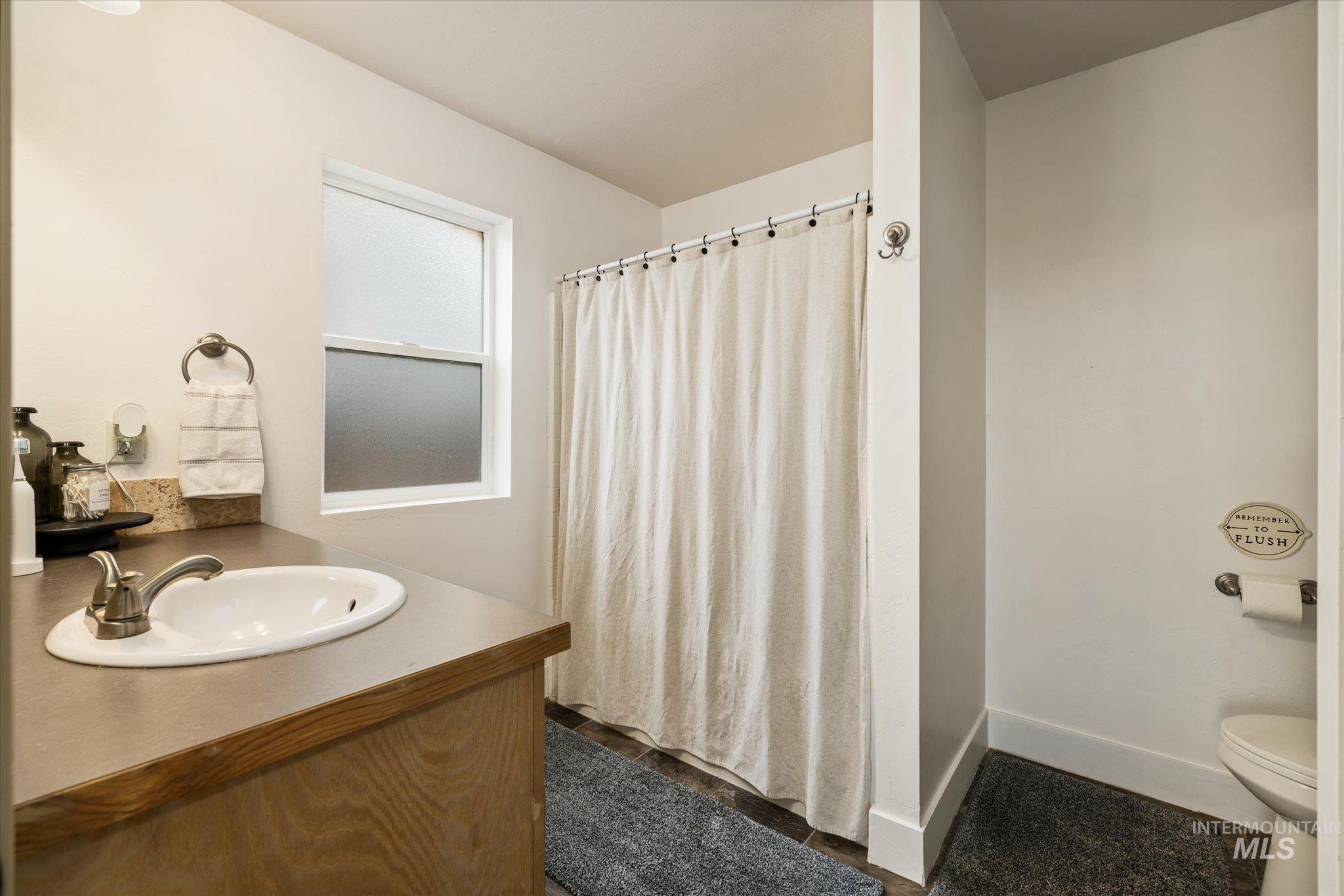 Full bath featuring a shower with shower curtain and vanity